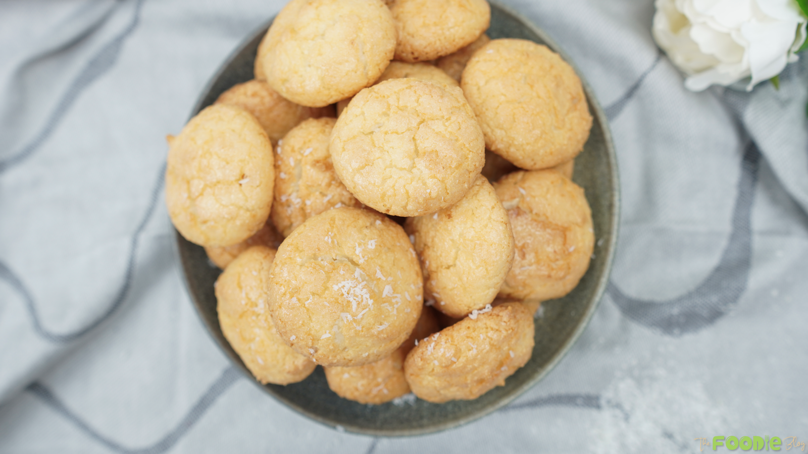 Overhead view of coconut macaroons stacked in a bowl