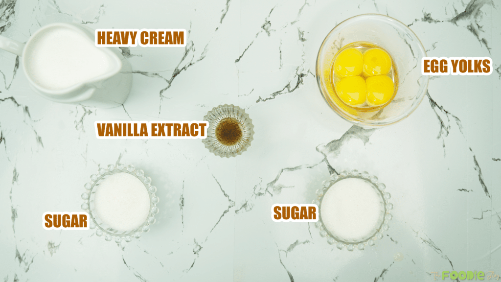 Heavy cream, egg yolks, sugar, and vanilla extract arranged for creme brulee