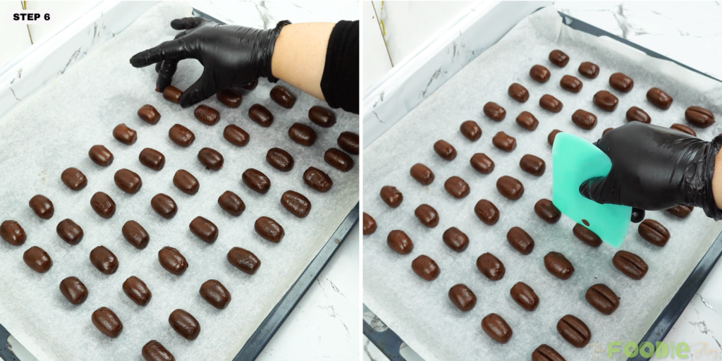 Small oval dough pieces arranged on a parchment-lined cookie sheet