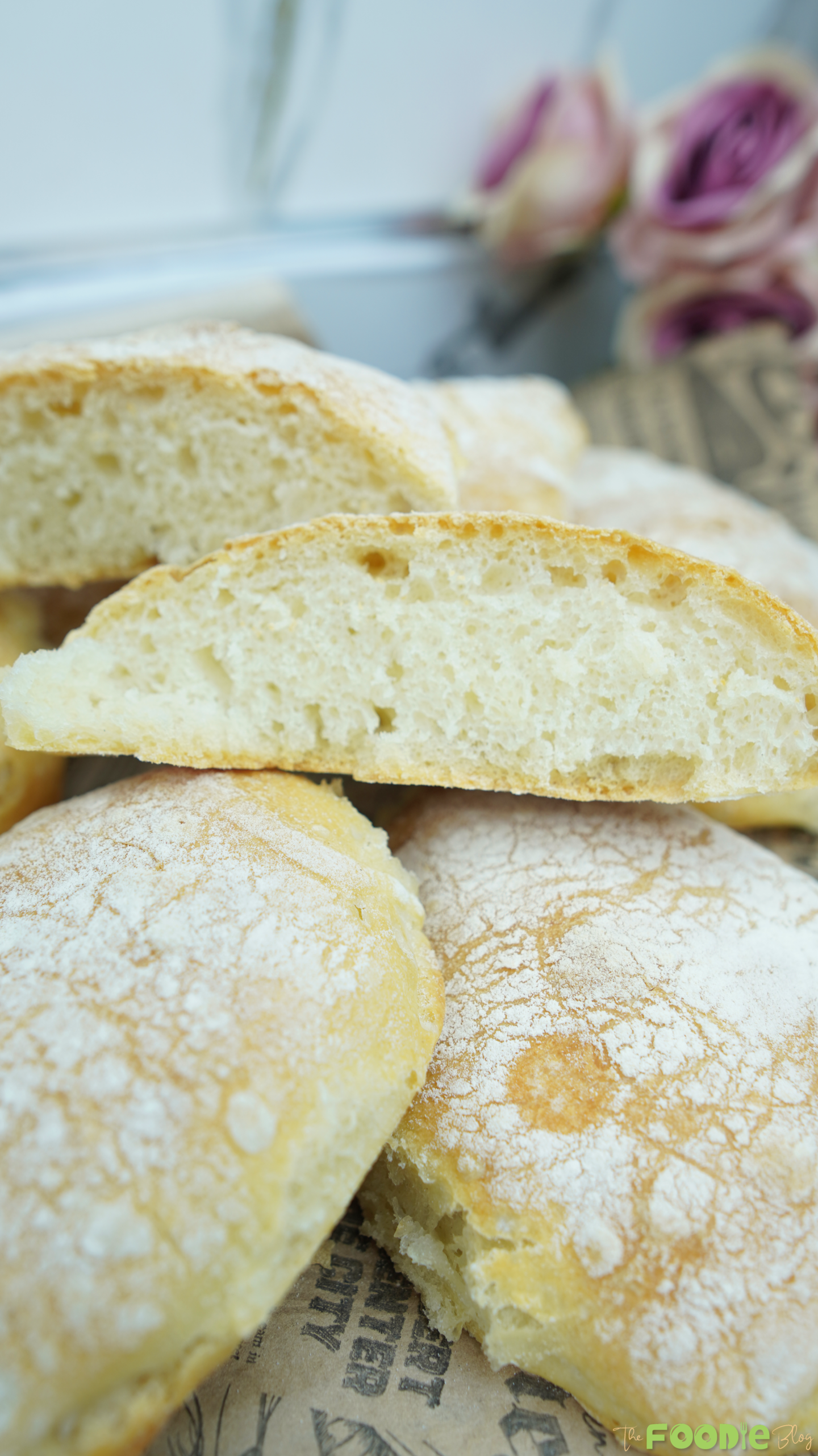 Close-up of sliced ciabatta showing an airy, tender crumb with a lightly floured crust