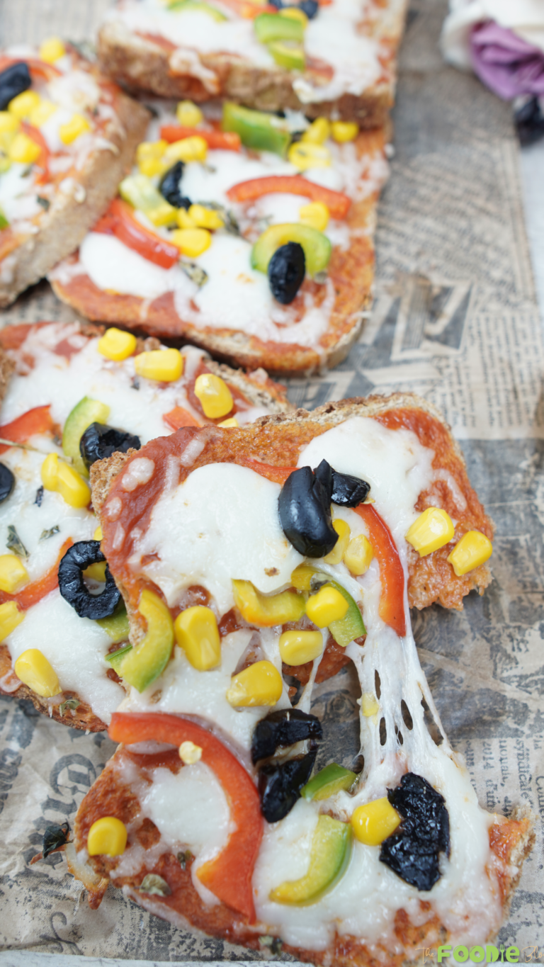 Close-up of EASY PIZZA TOAST with stretchy mozzarella, corn, bell peppers, and black olives