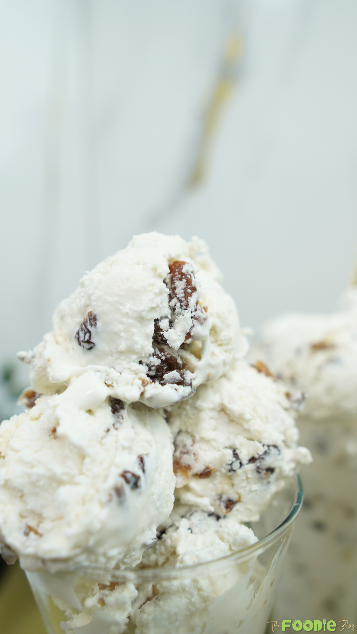 Close-up of a scoop of Easy Rum Ice Cream with raisins and a glossy creamy finish