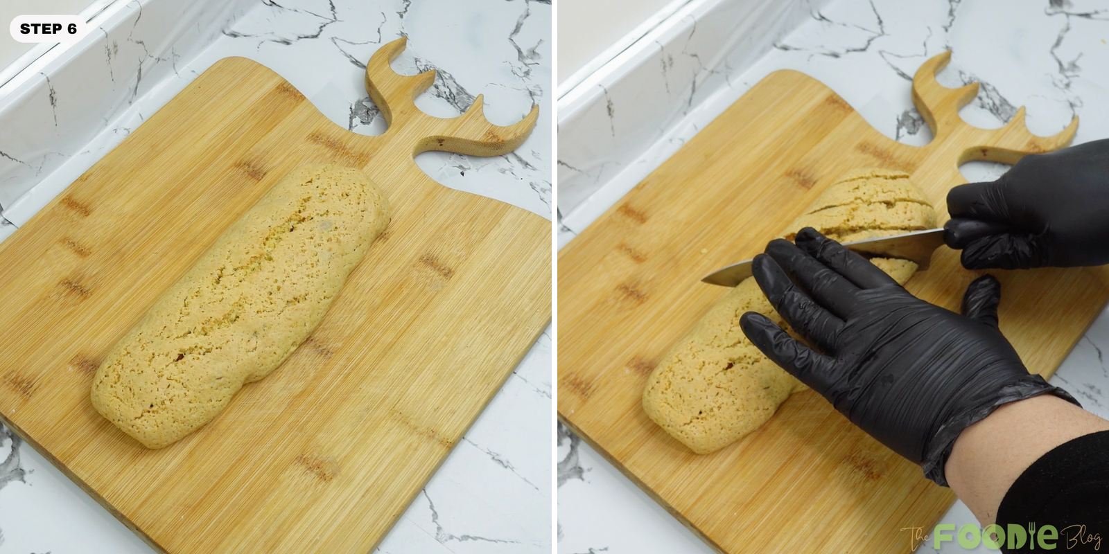 A baked biscotti log being sliced diagonally on a wooden board
