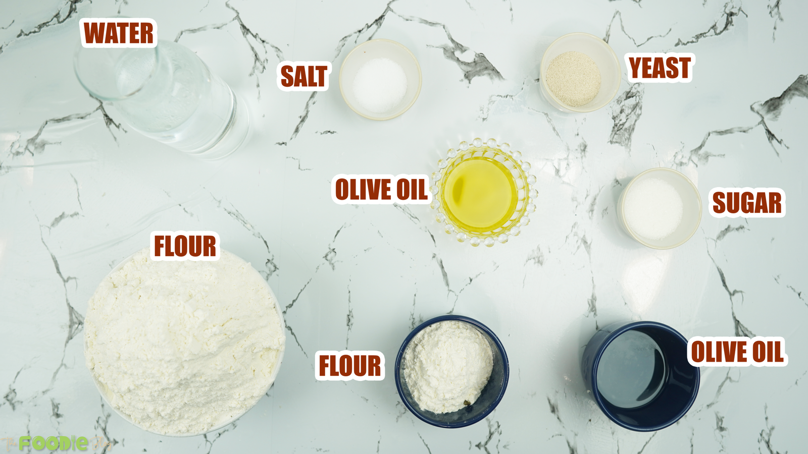 Bowls of flour, yeast, sugar, salt, water, and olive oil for pizza dough