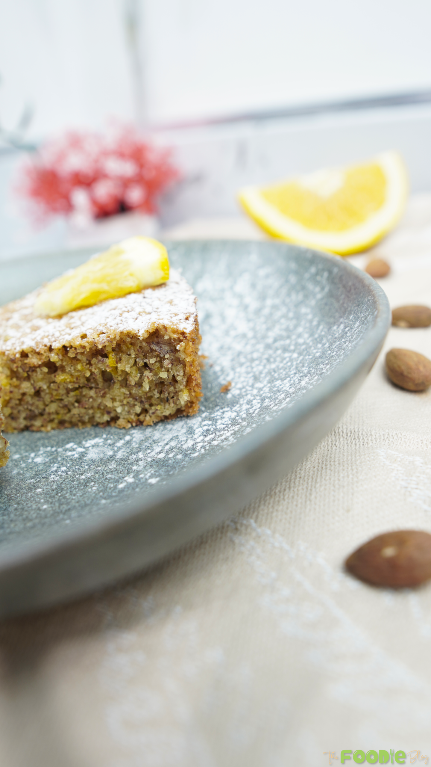 Close-up view of the almond cake slice showing moist texture and citrus zest bits