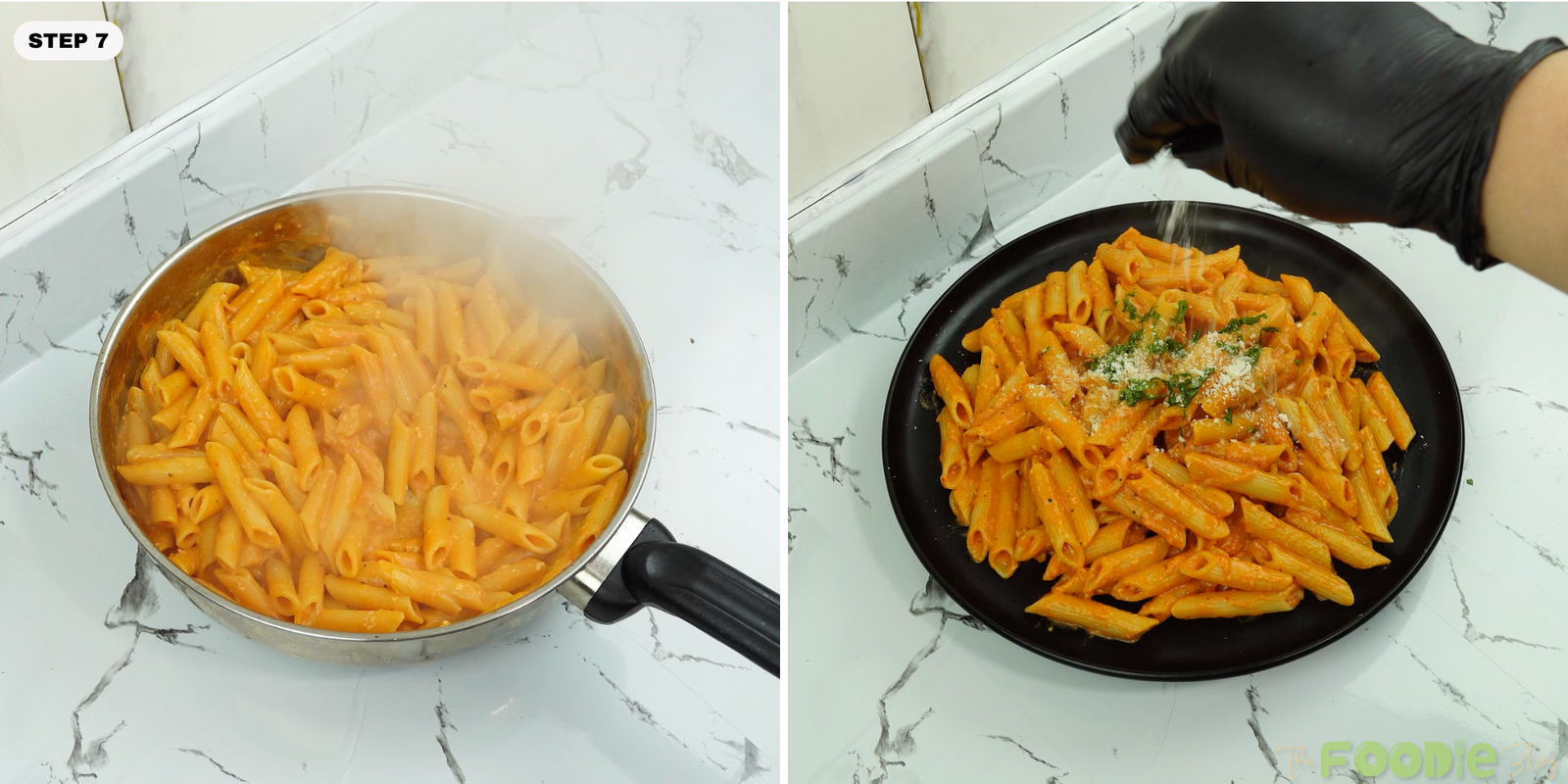 Penne alla vodka served on a black plate with Parmesan and parsley being sprinkled on top