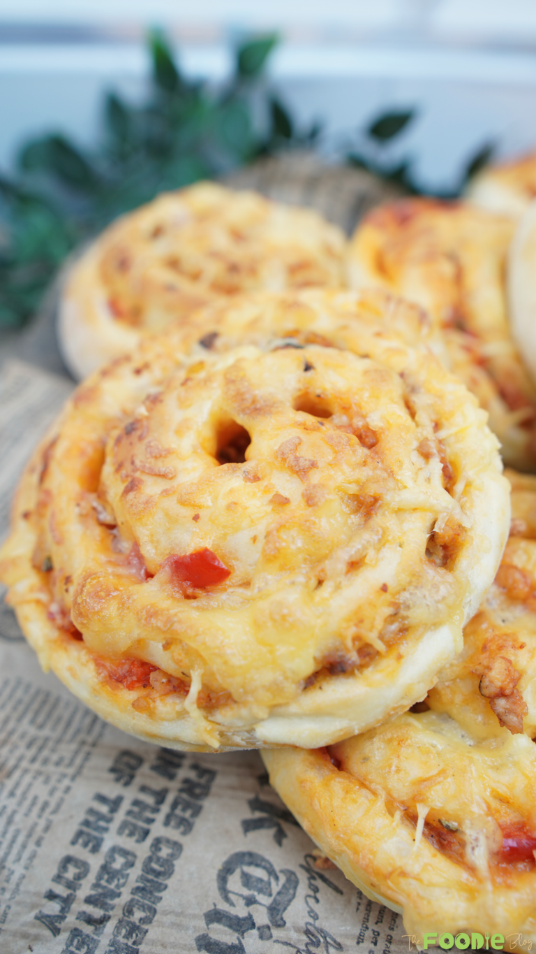 Close-up of cheesy Pizza Rolls with golden tops and a visible spiral shape