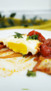 A tight close-up of shakshuka with a runny yolk and parsley on top