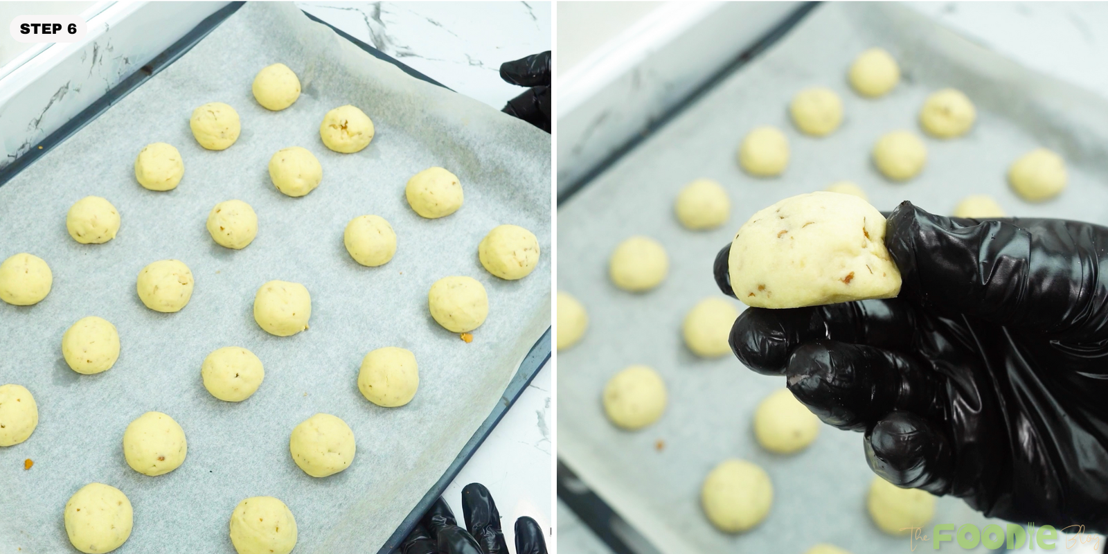 Baked cookies on parchment with one cookie held in hand before coating
