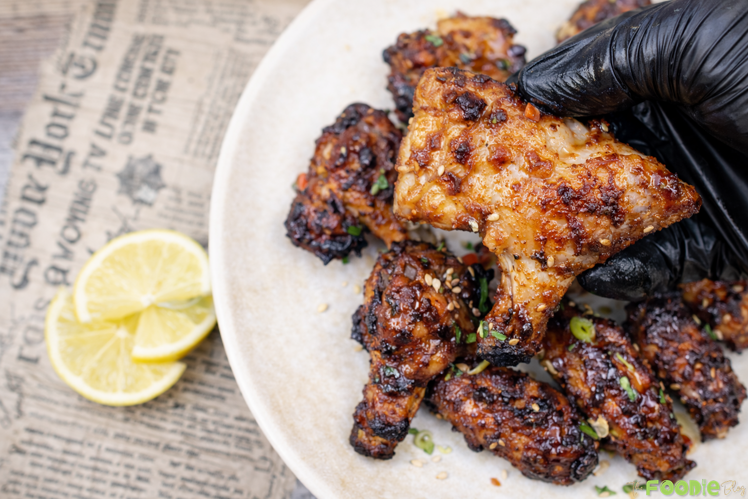 Sticky Chinese chicken wings glazed with hoisin, soy, garlic, and honey, served with fresh lemon slices.