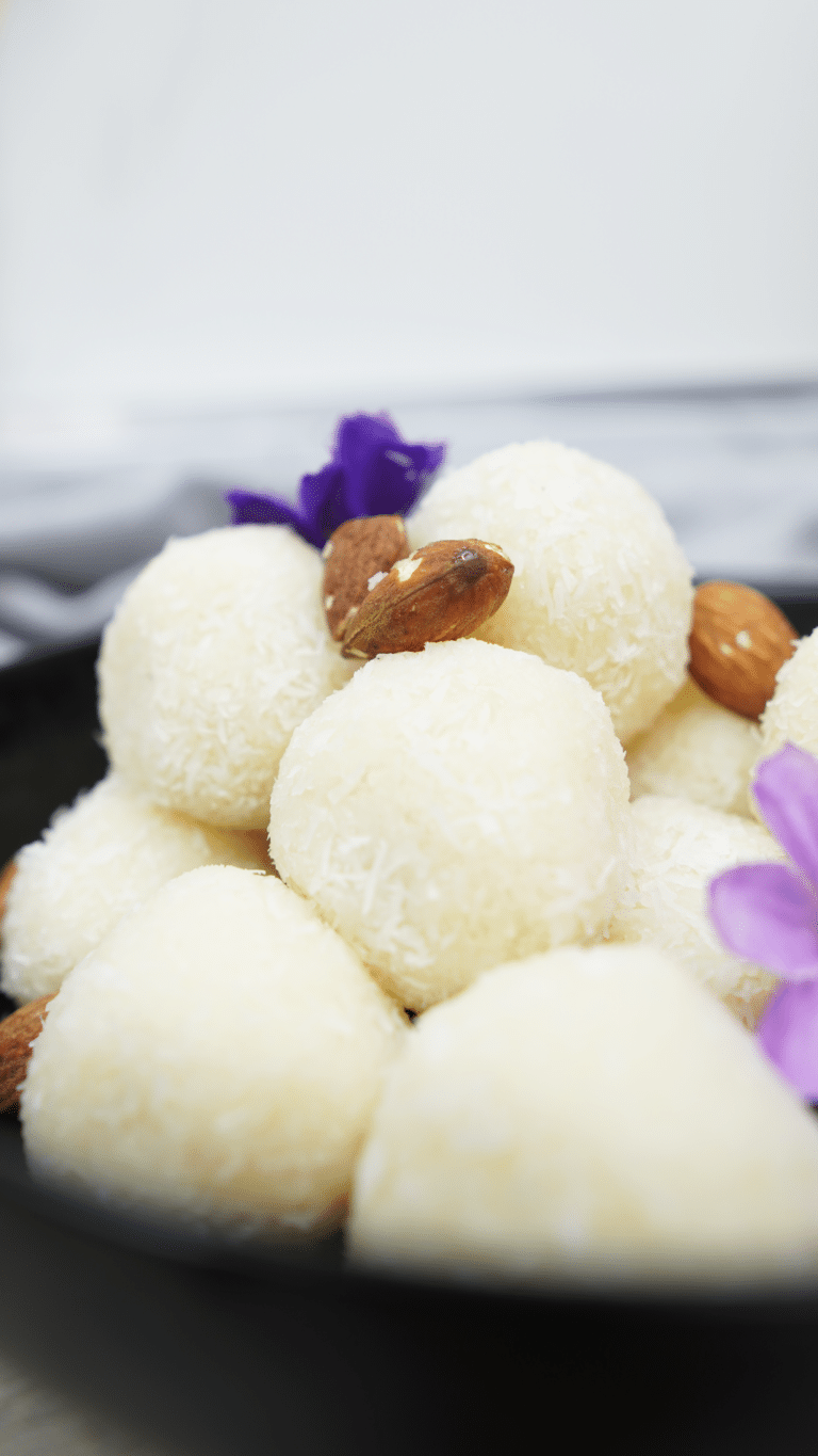 Close-up of coconut-coated balls with almonds in the bowl