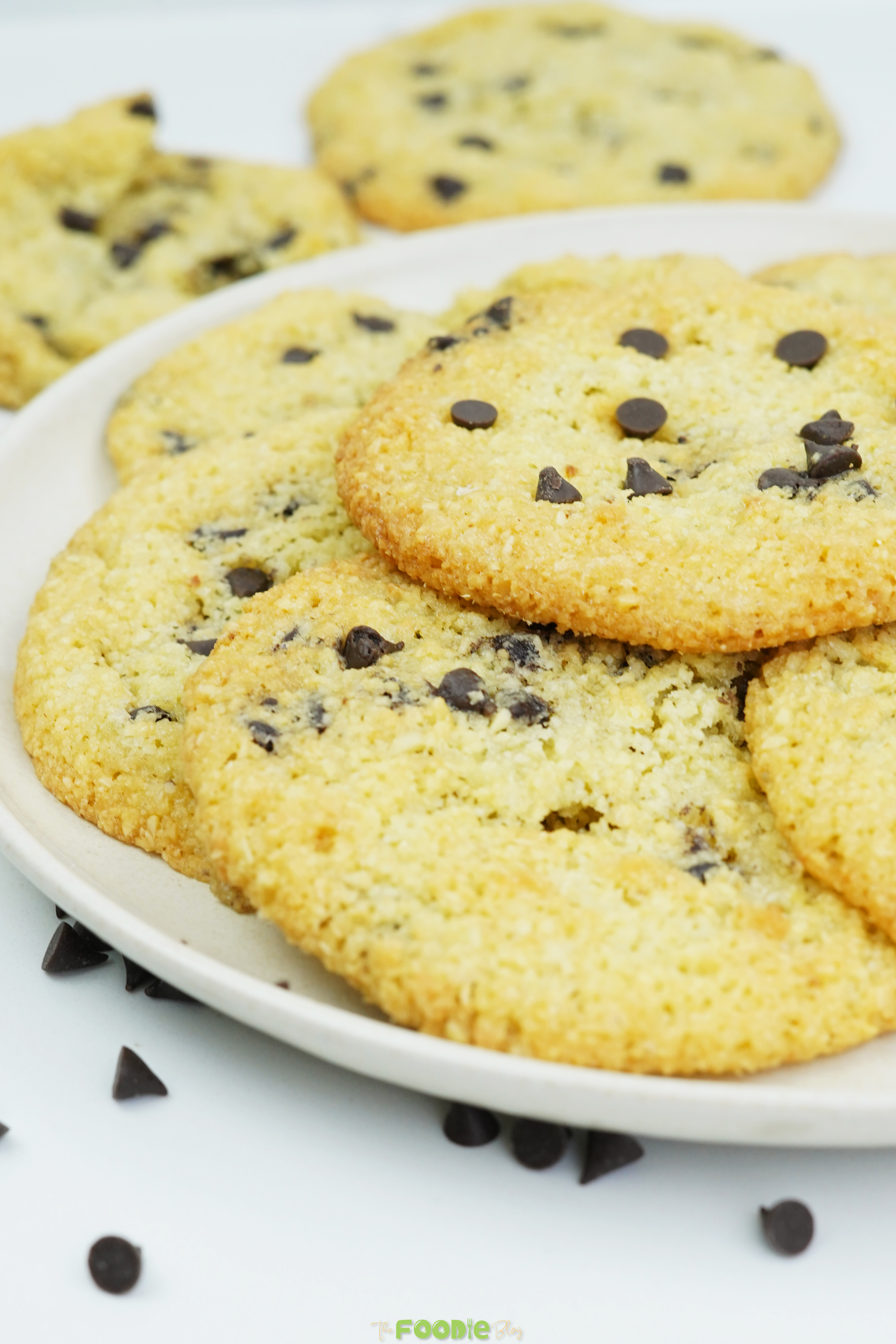 Close-up of almond flour chocolate chip cookies on a plate with mini chocolate chips on top
