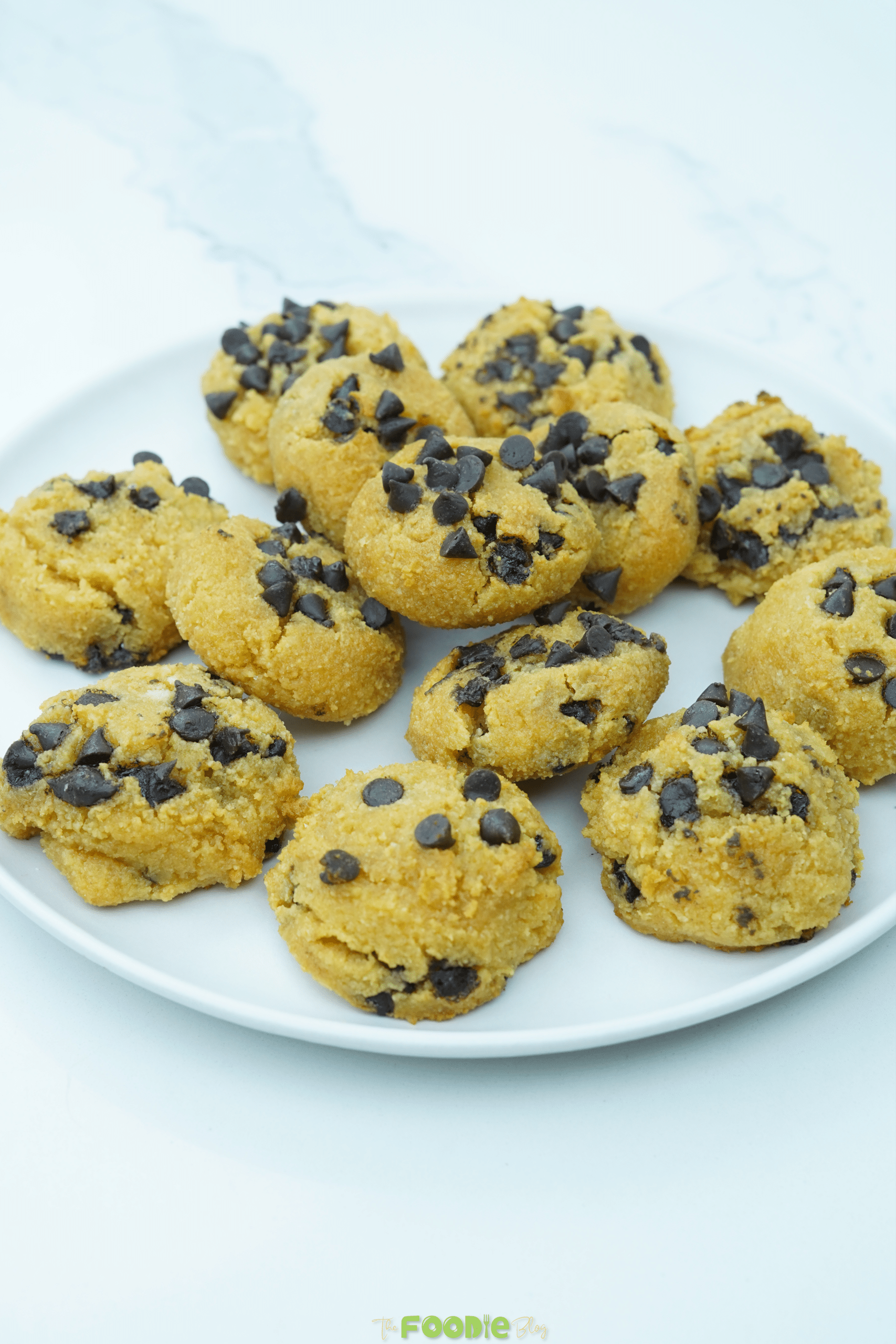 Stack of cottage cheese chocolate chip cookies on a white plate