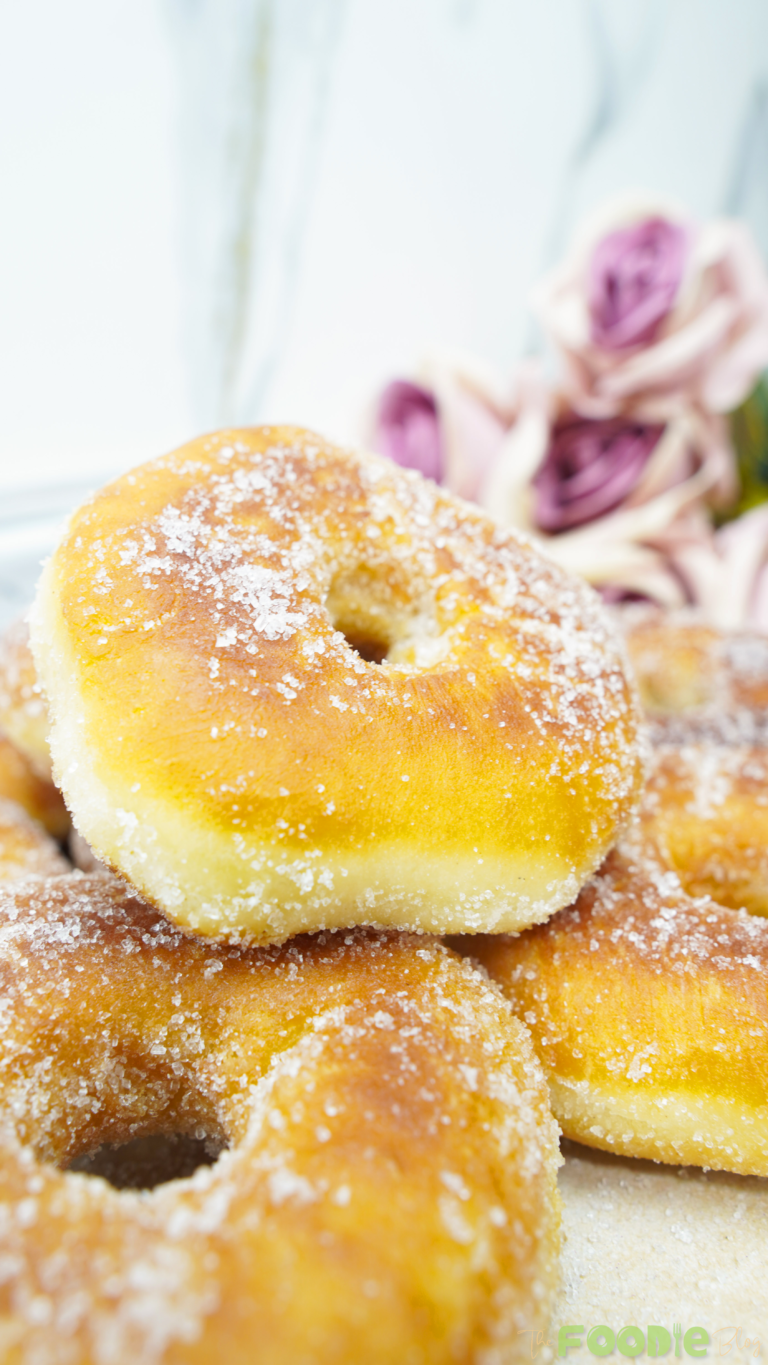 Close-up of a fluffy fried donut coated with granulated sugar