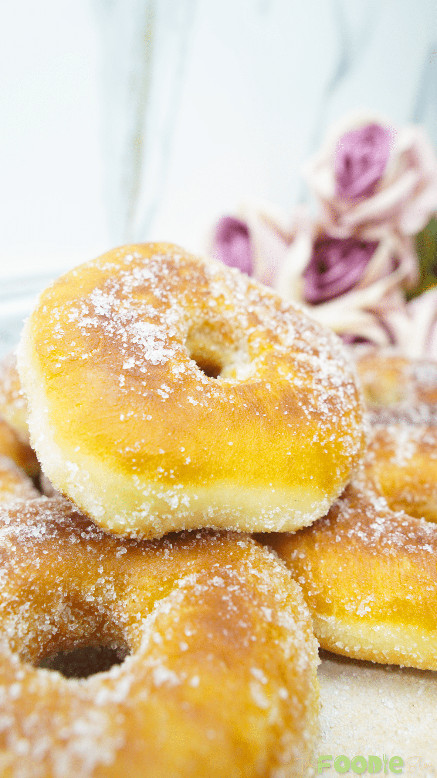 Close-up of a fluffy fried donut coated with granulated sugar