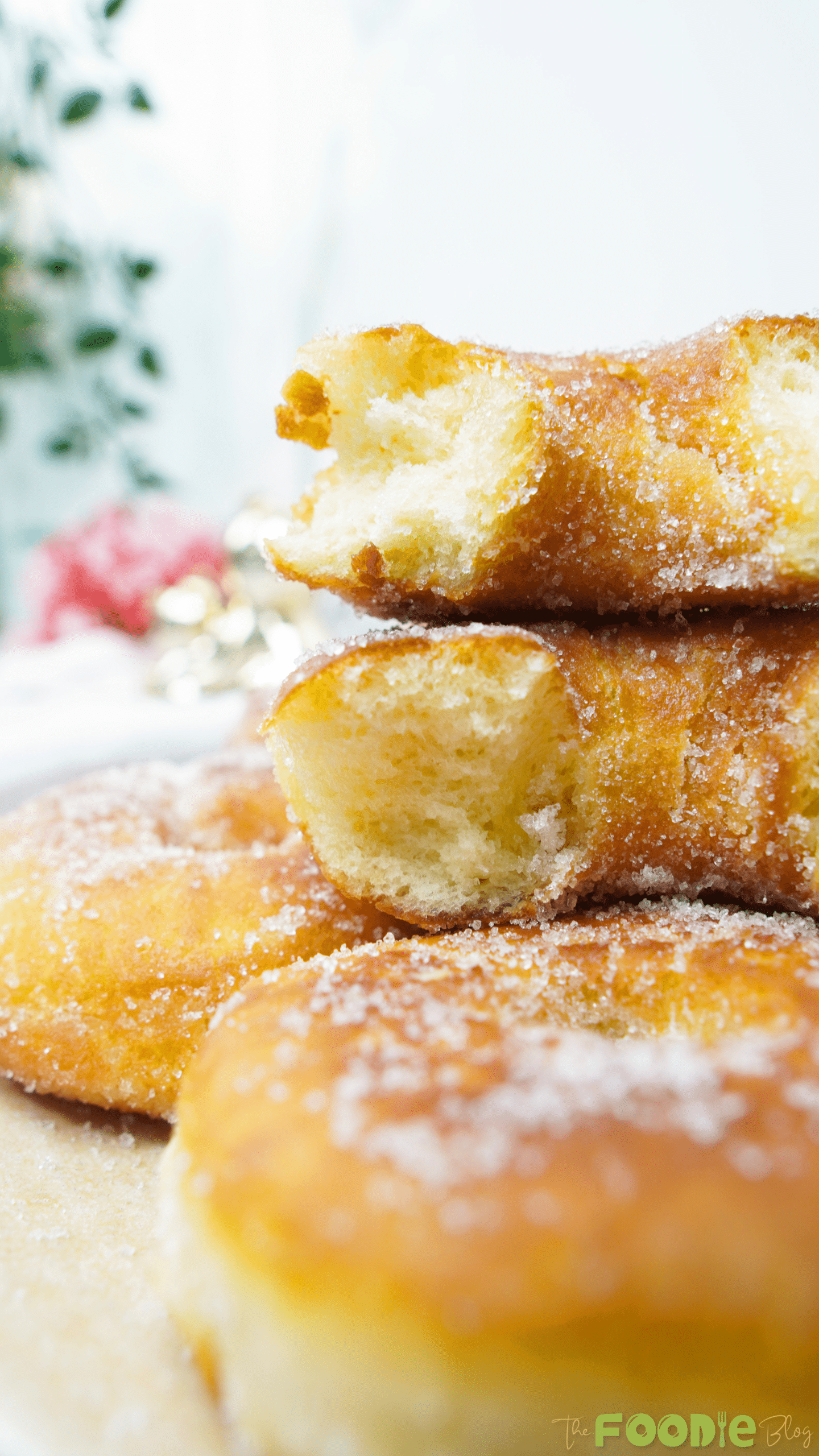 Bitten sugar-coated donut showing a soft, fluffy interior crumb