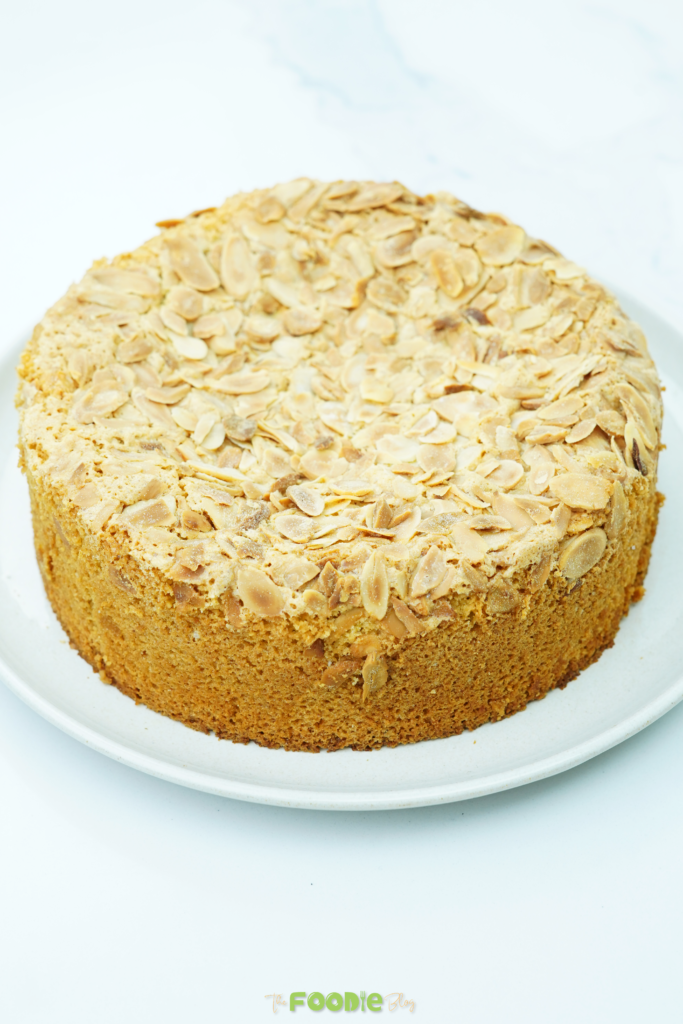Close-up of flourless almond cake showing the sliced almond topping and golden edges