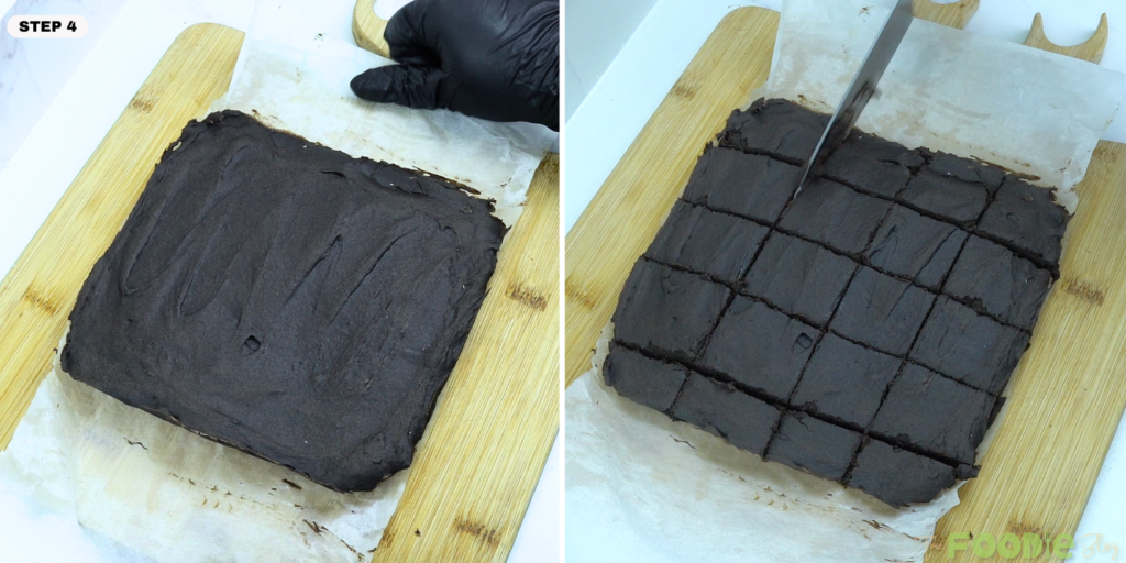 Set brownie slab being lifted and cut into squares on a cutting board