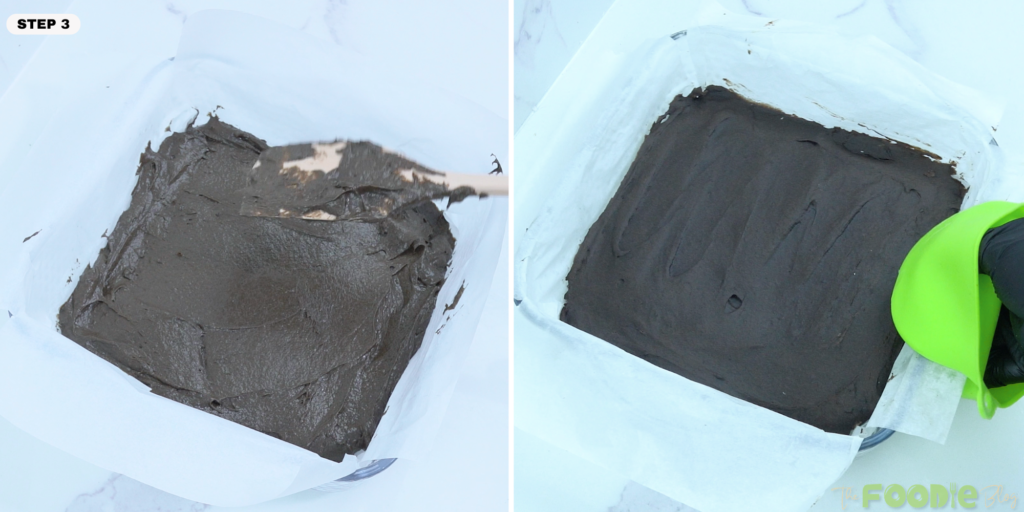 Thick chocolate batter spread evenly in a parchment-lined pan
