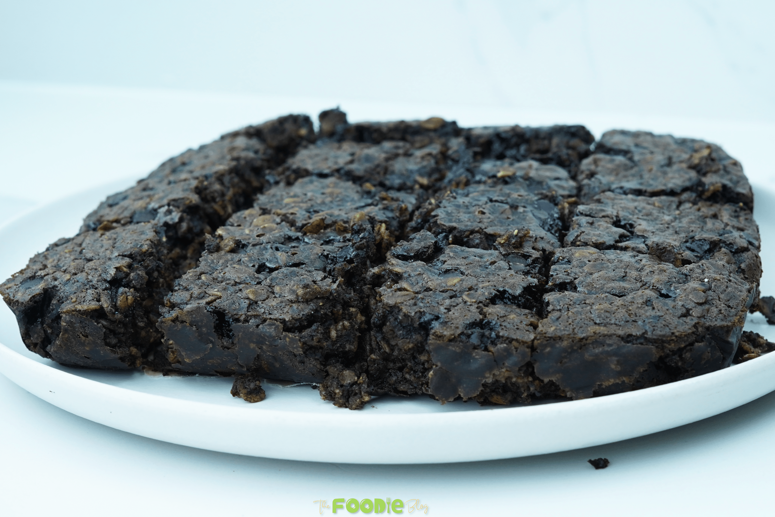 Plated oatmeal brownie squares showing the thick edges