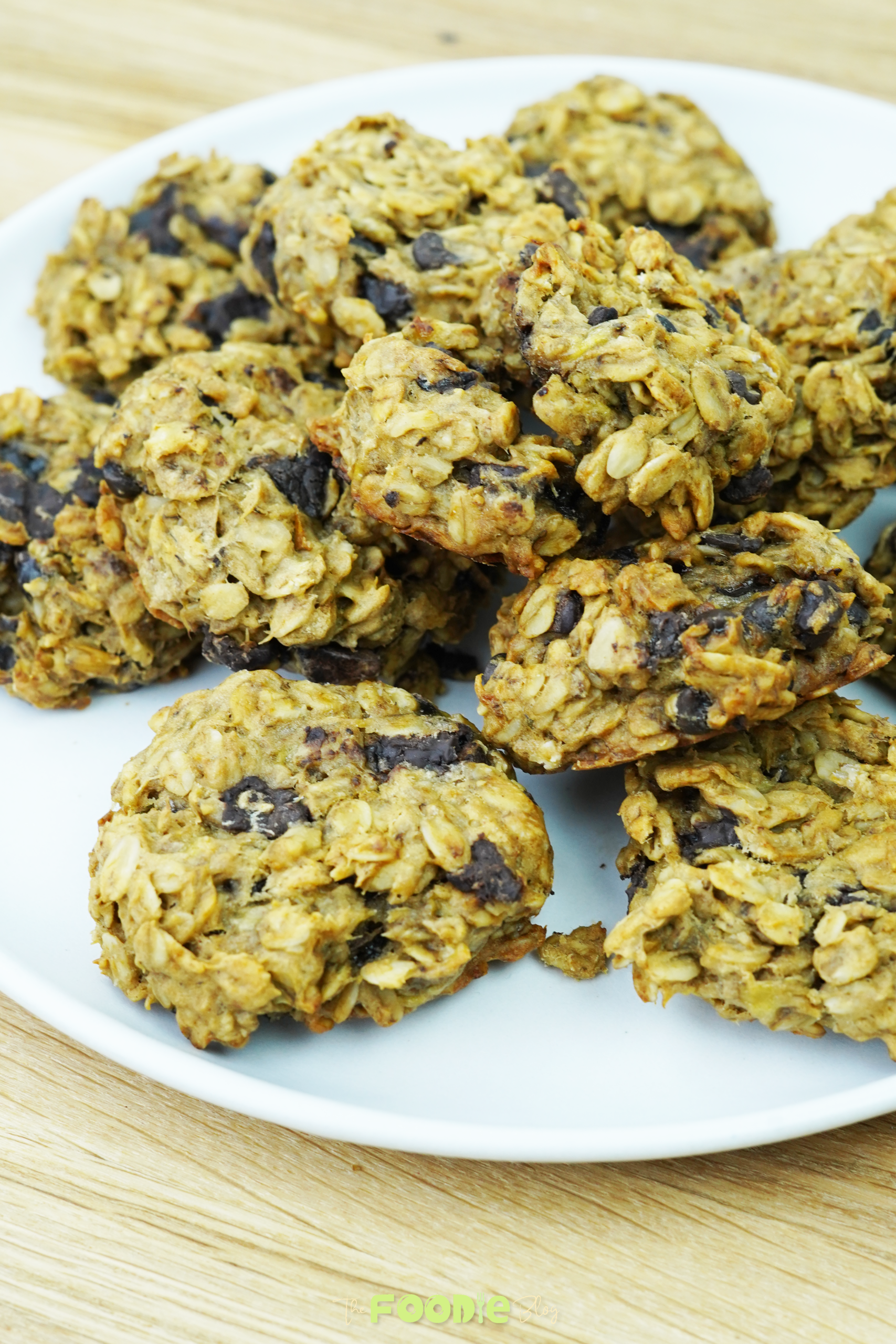 Close-up of an oatmeal chocolate chip cookie on parchment paper