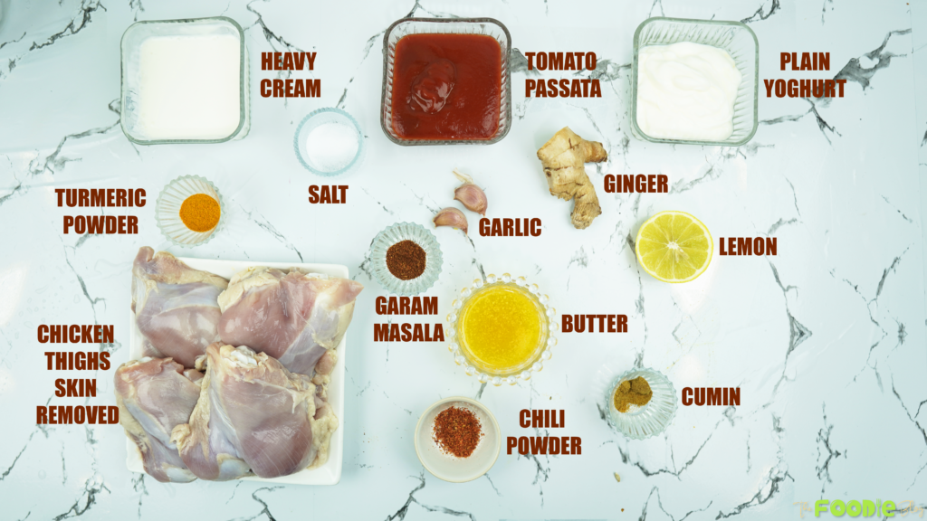 Ingredients for baked butter chicken including chicken thighs, passata, cream, yogurt, butter, and spices