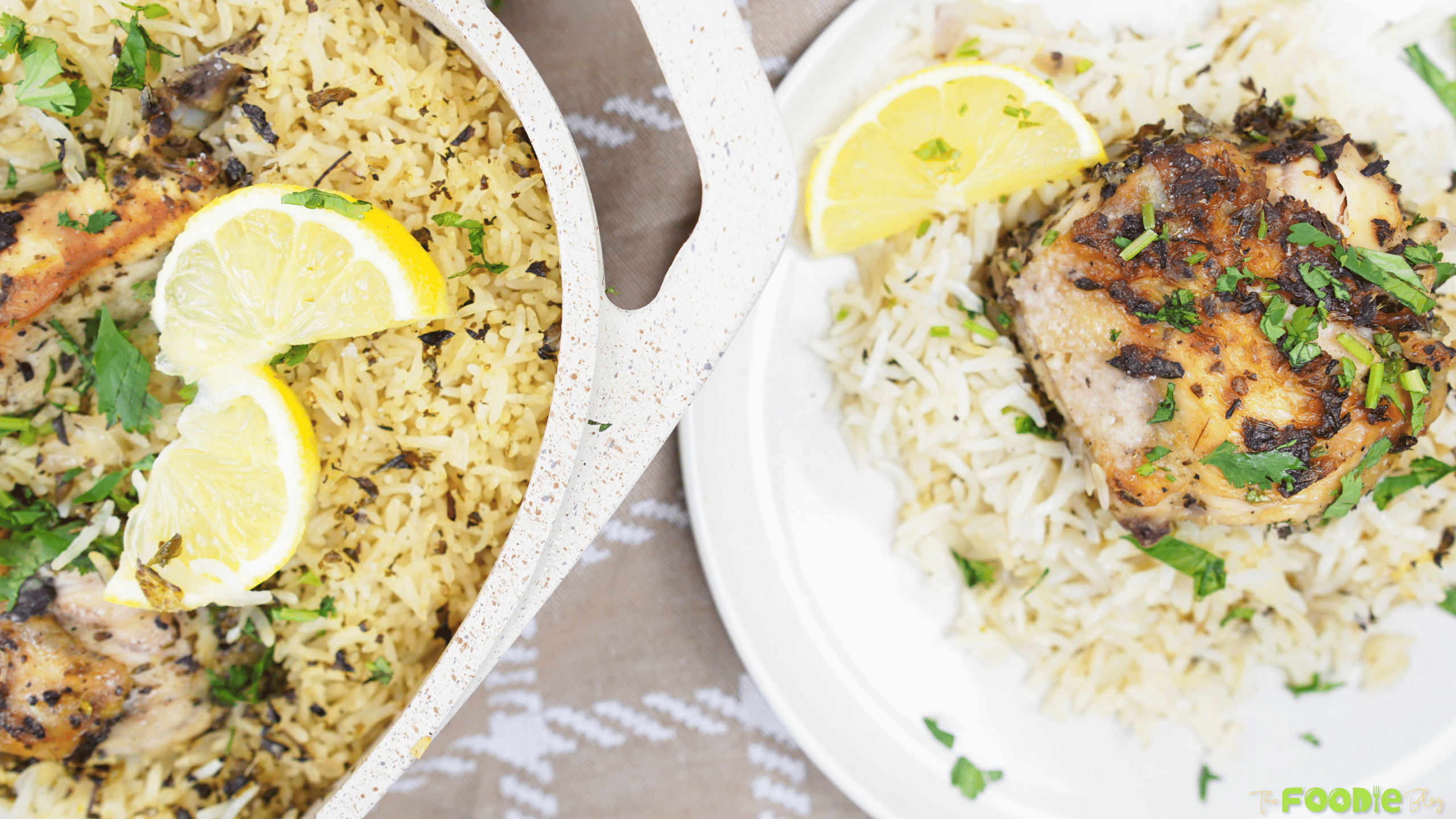 One pot chicken and lemon rice served with a lemon wedge and chopped parsley