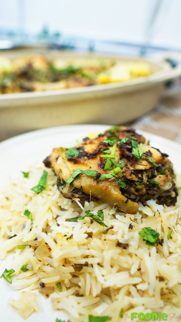 Close-up of a piece of chicken on lemon herb rice with parsley on top