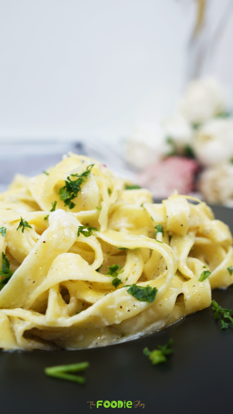 Close-up of creamy garlic parmesan pasta on a black plate