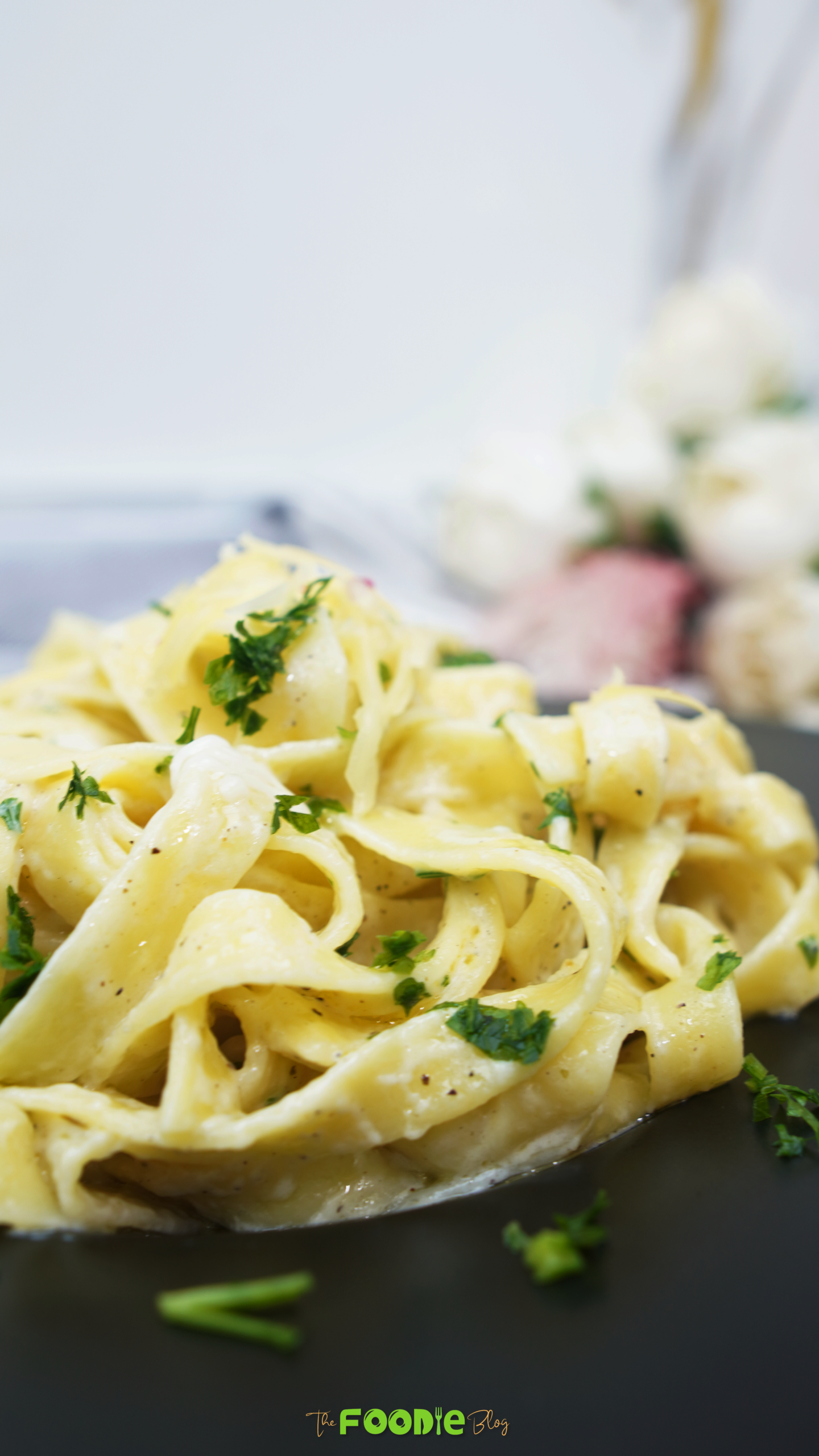 Close-up of creamy garlic parmesan pasta on a black plate
