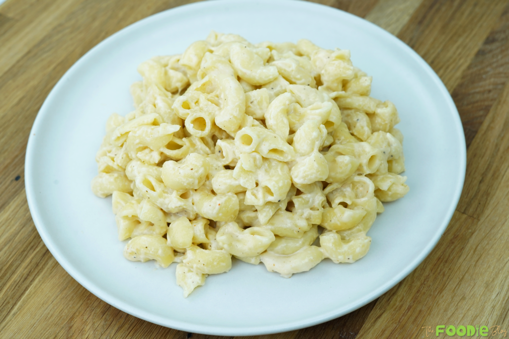 Serving of creamy one pot mac and cheese piled in a white bowl