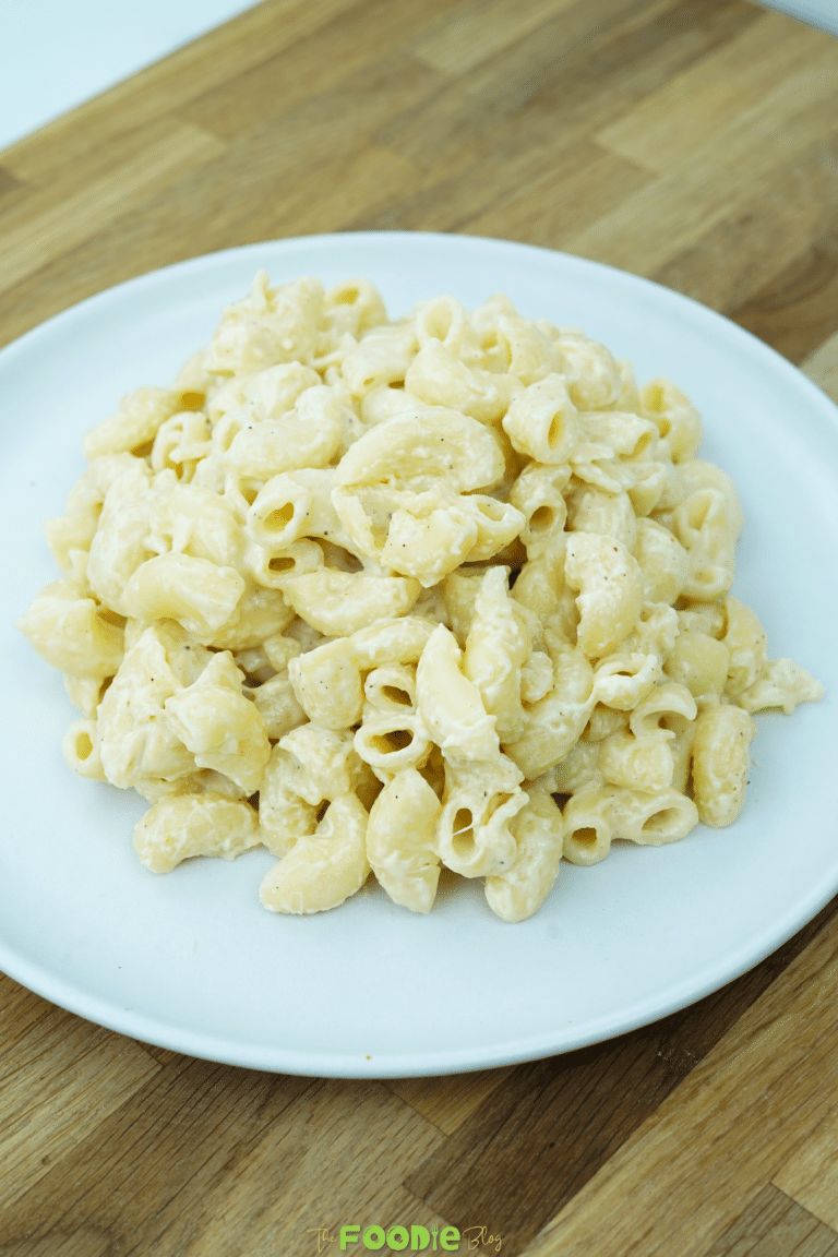 Creamy one pot mac and cheese served in a white bowl on a wooden surface