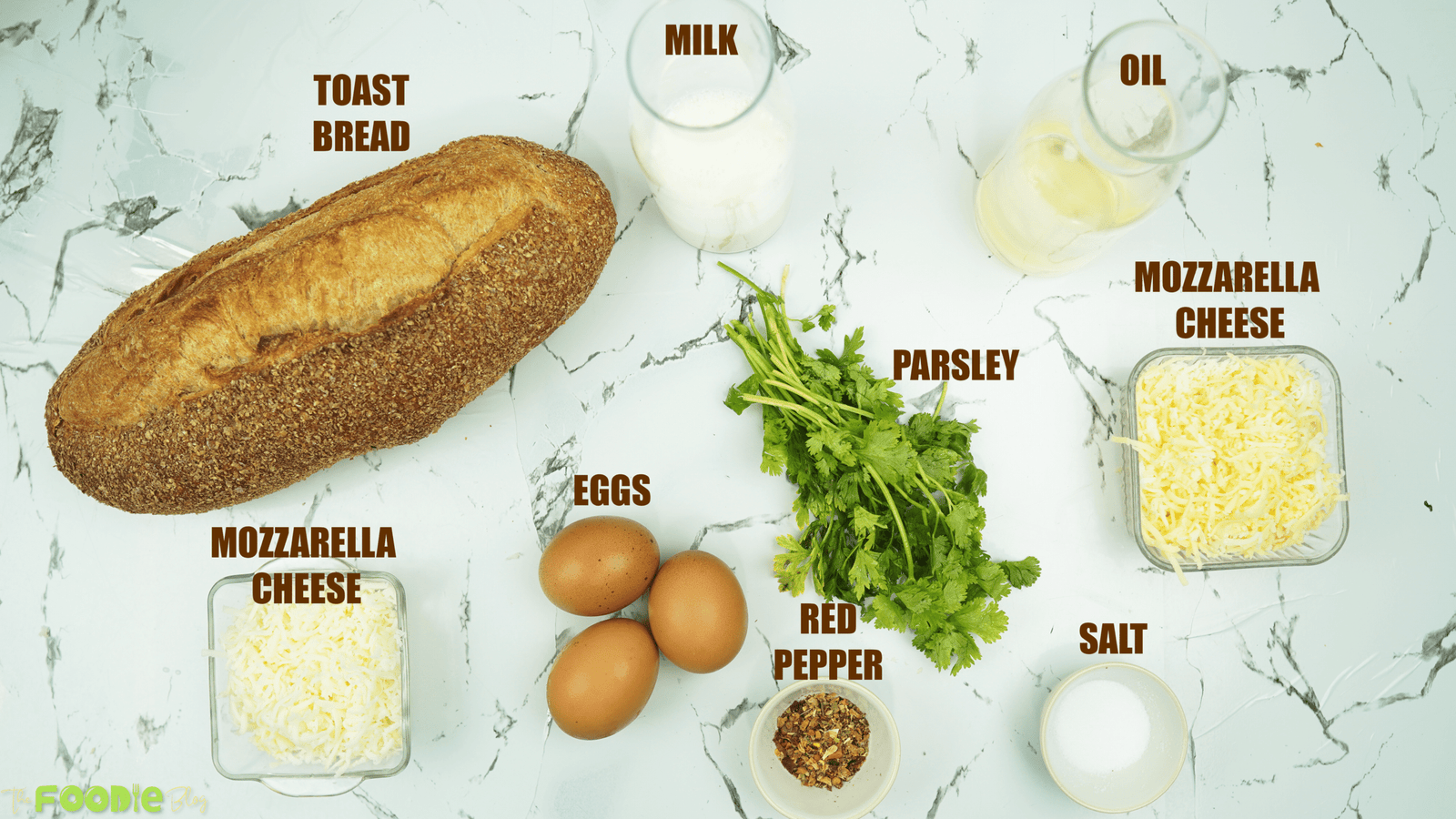Overhead view of bread, eggs, milk, oil, parsley, salt, red pepper, and mozzarella cheese
