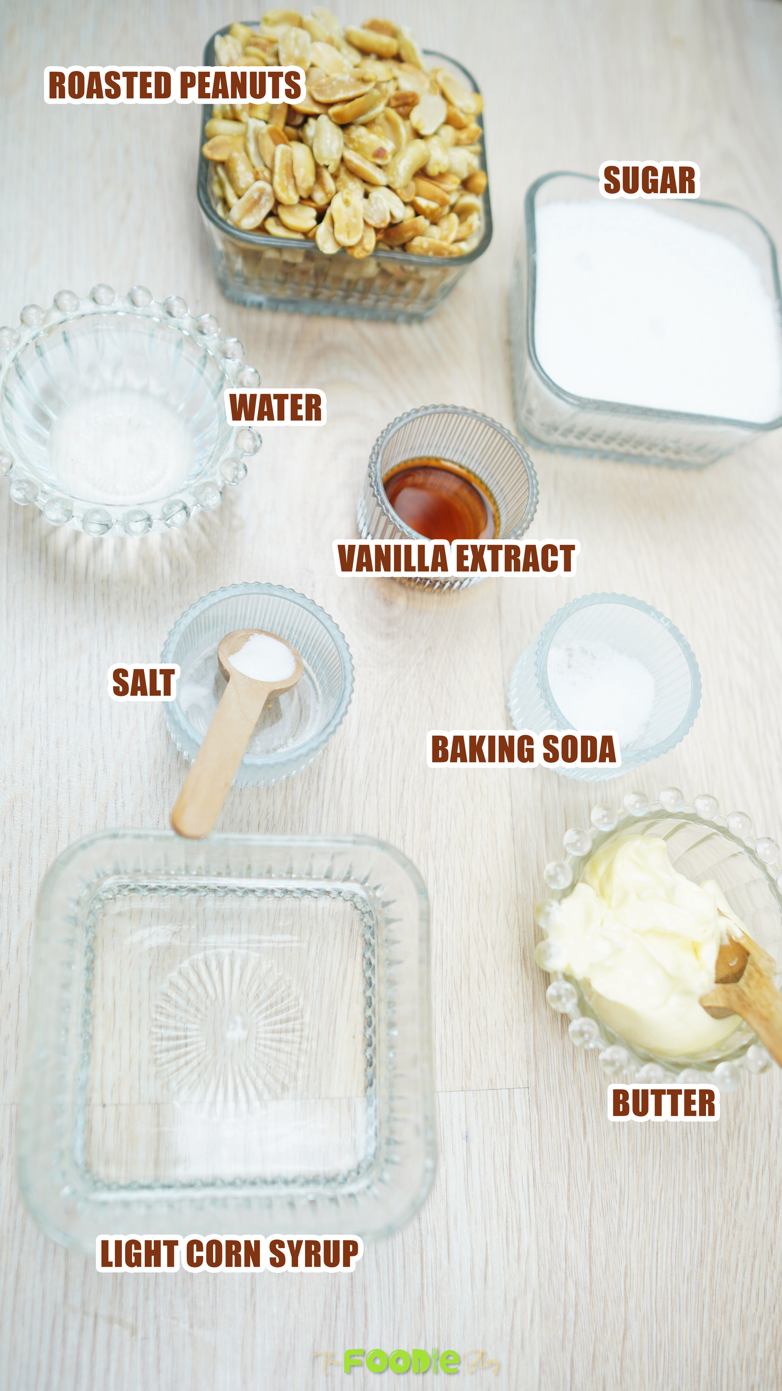 Measured ingredients for peanut brittle including sugar, corn syrup, butter, peanuts, vanilla, salt, and baking soda
