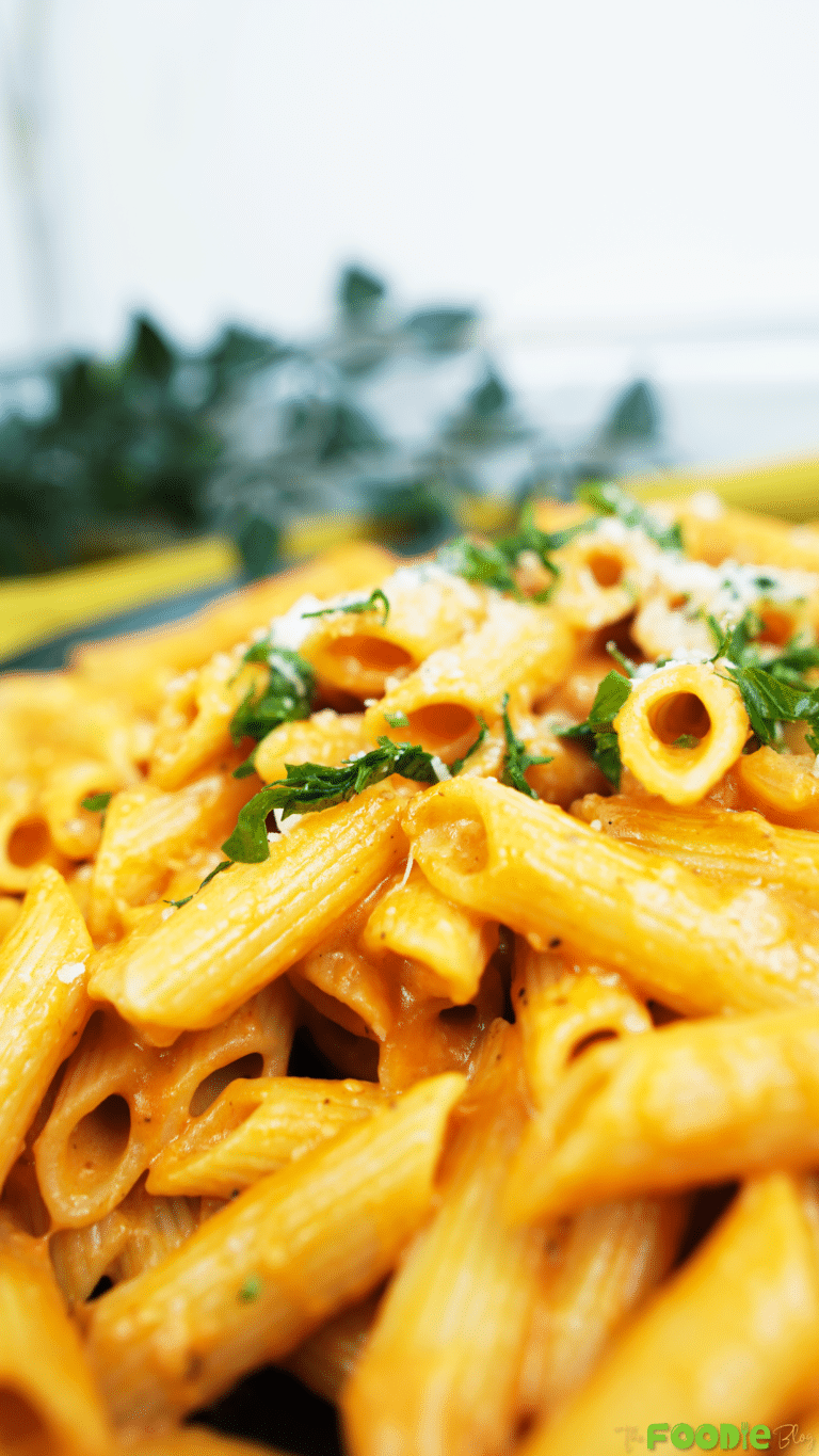 Close-up of penne coated in creamy tomato vodka sauce with Parmesan and parsley