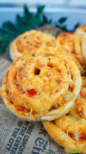 Close-up of cheesy Pizza Rolls with golden tops and a visible spiral shape