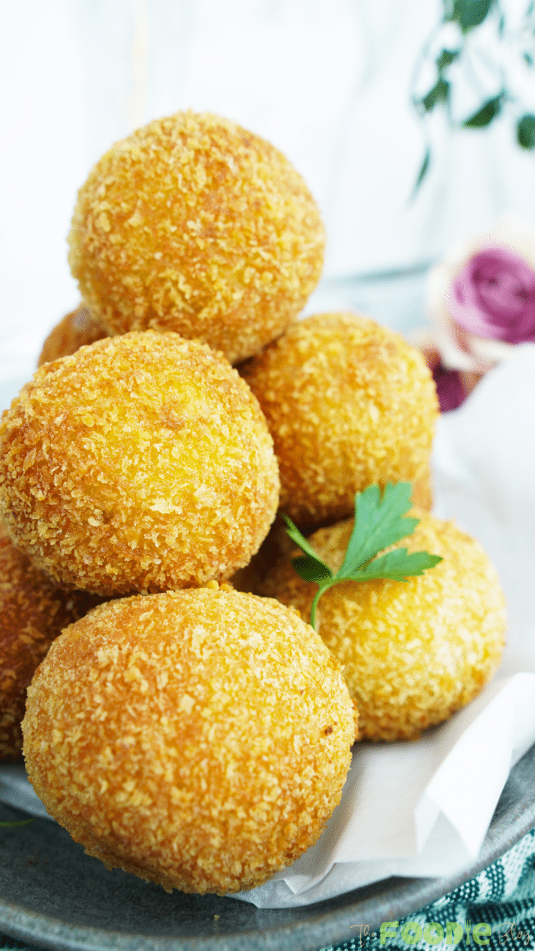 Close-up of crunchy potato cheese balls with a golden breadcrumb coating
