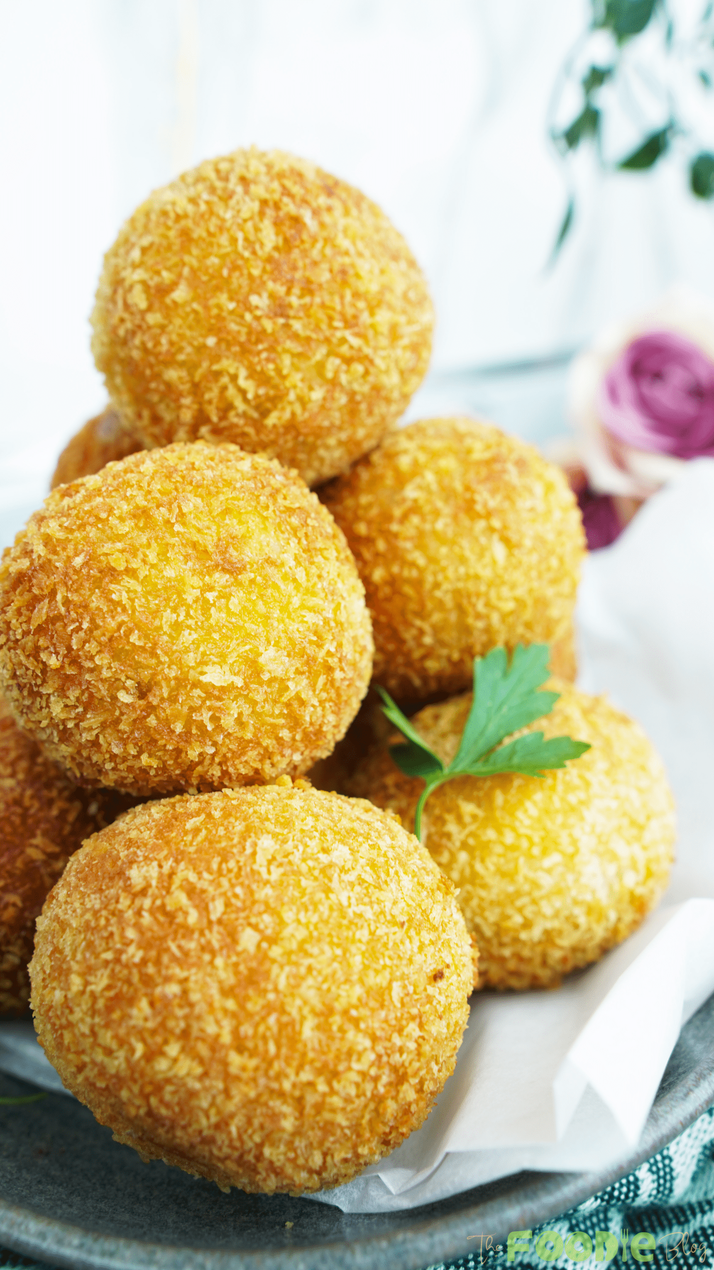 Close-up of crunchy potato cheese balls with a golden breadcrumb coating