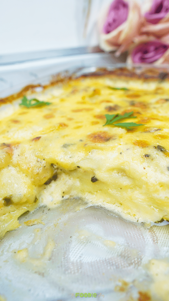 Close-up of creamy potatoes au gratin with a scoop removed showing the tender layers