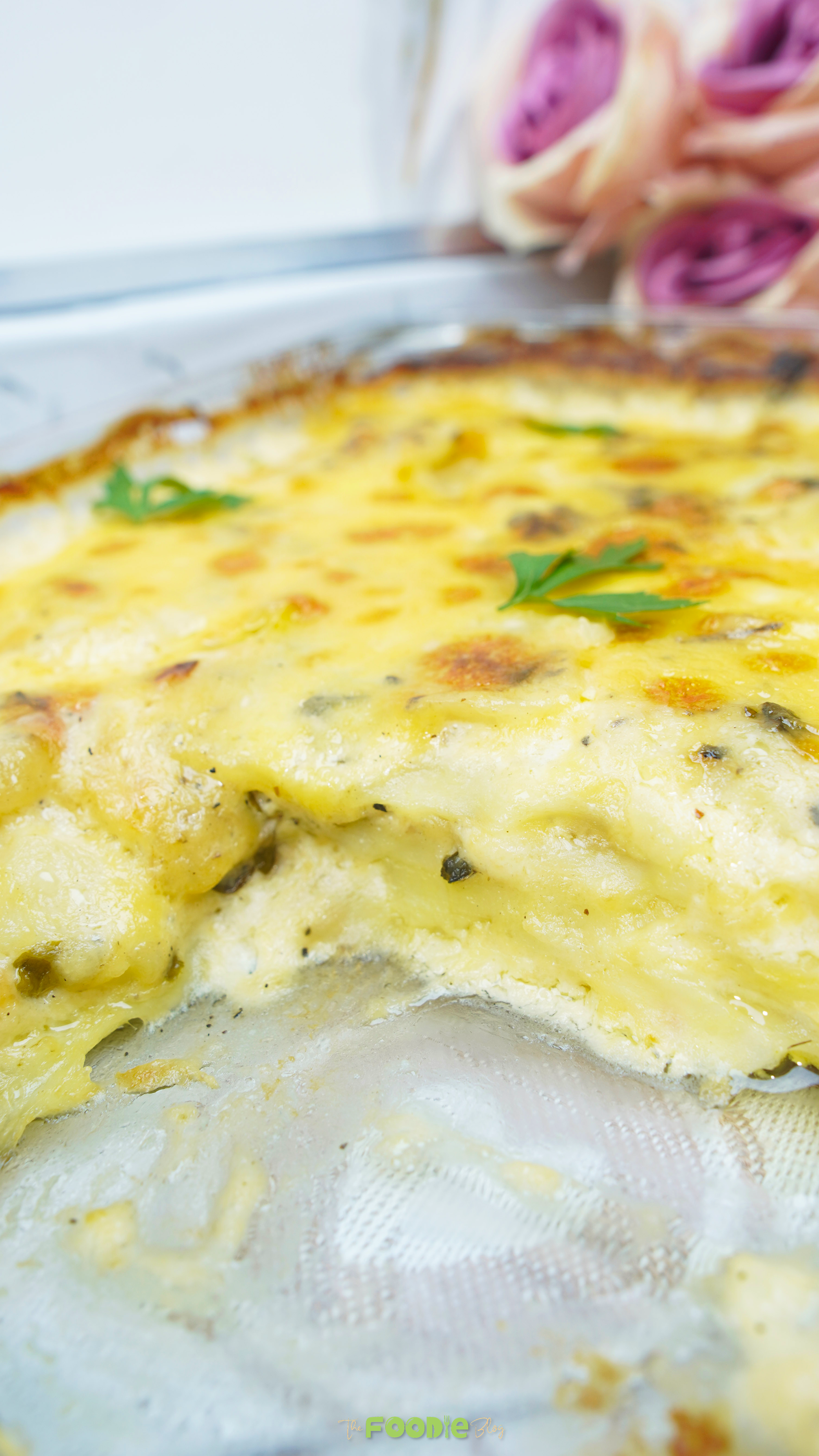 Close-up of creamy potatoes au gratin with a scoop removed showing the tender layers