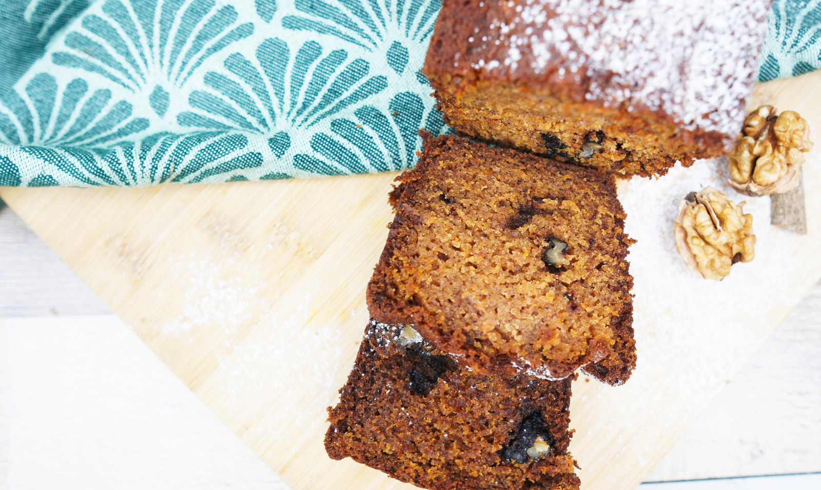 Close-up of a pumpkin bread slice with a moist crumb and nut pieces
