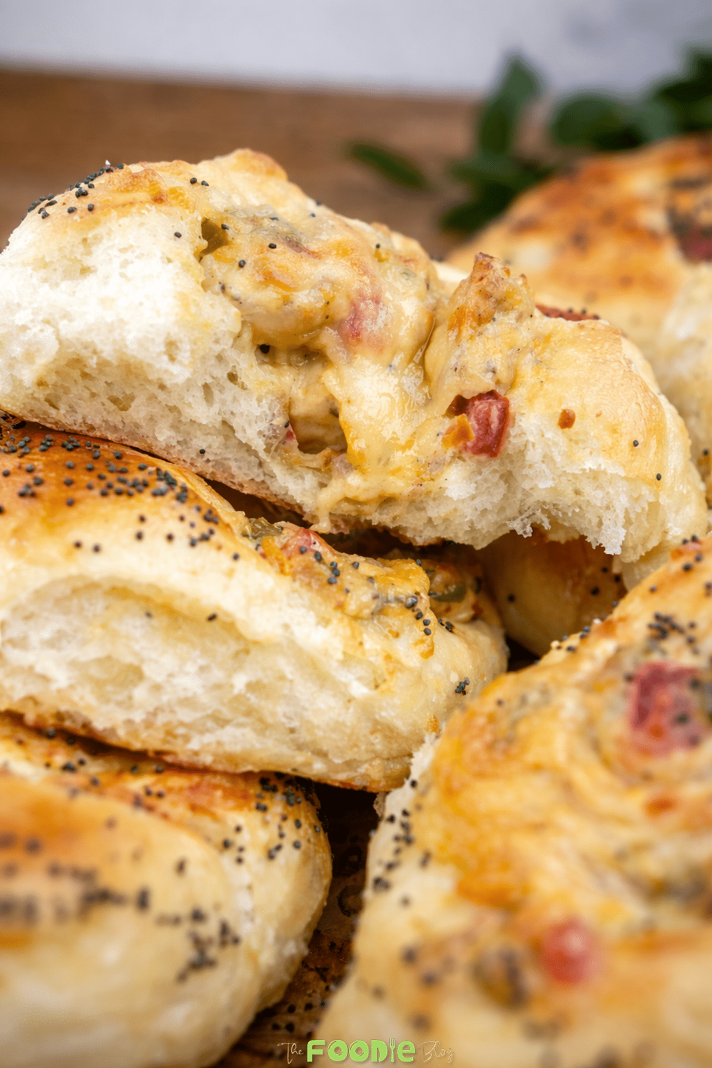 Close-up of soft cheese pizza bread torn open to show the fluffy interior and cheesy chicken and pepper filling.