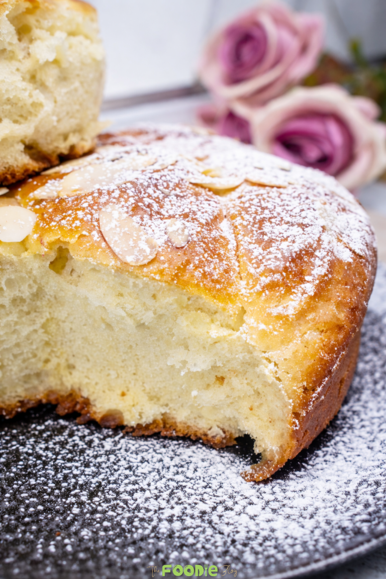 photo of soft homemade brioche bread showing the finished loaf and a fluffy sliced piece held by hand.