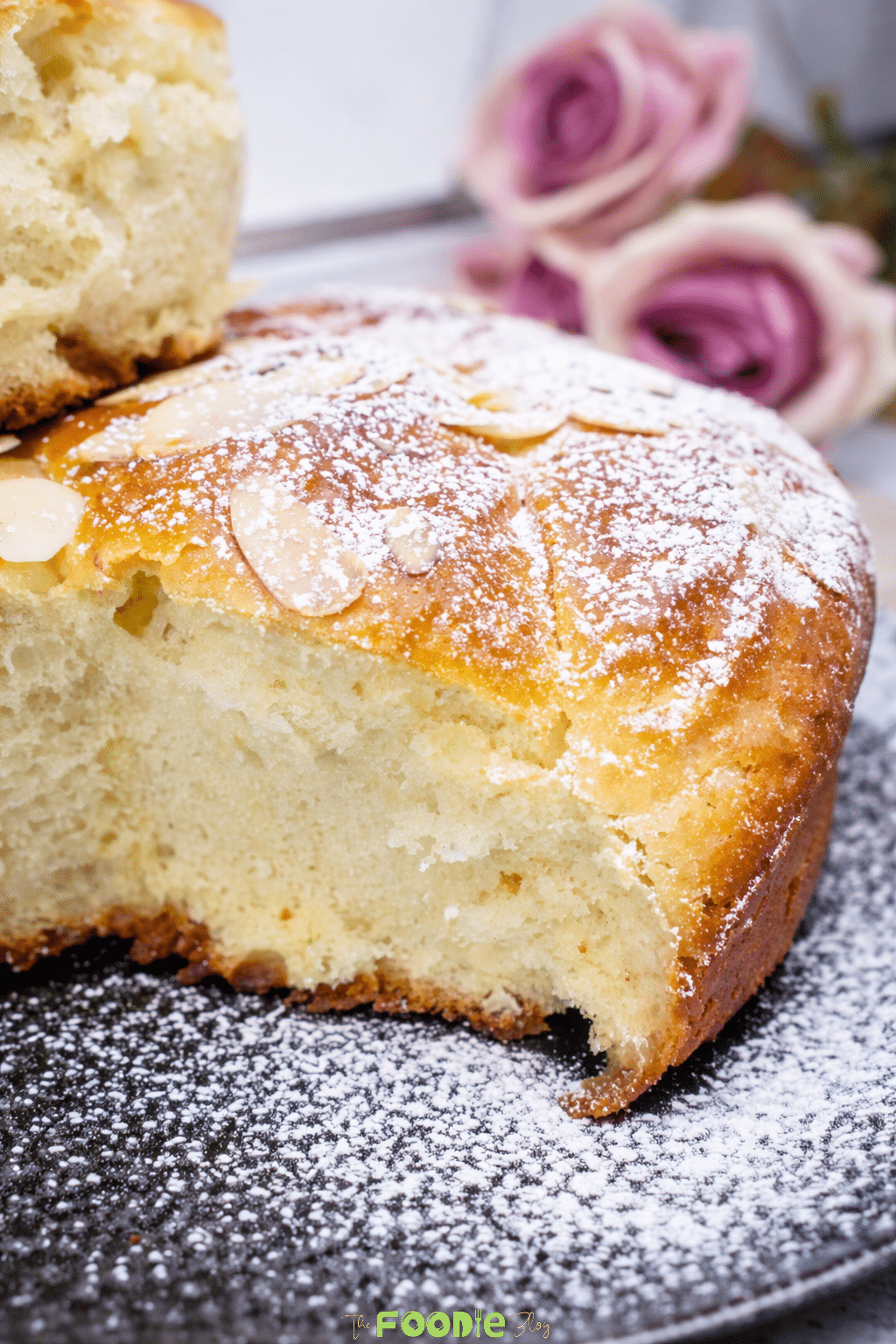 photo of soft homemade brioche bread showing the finished loaf and a fluffy sliced piece held by hand.