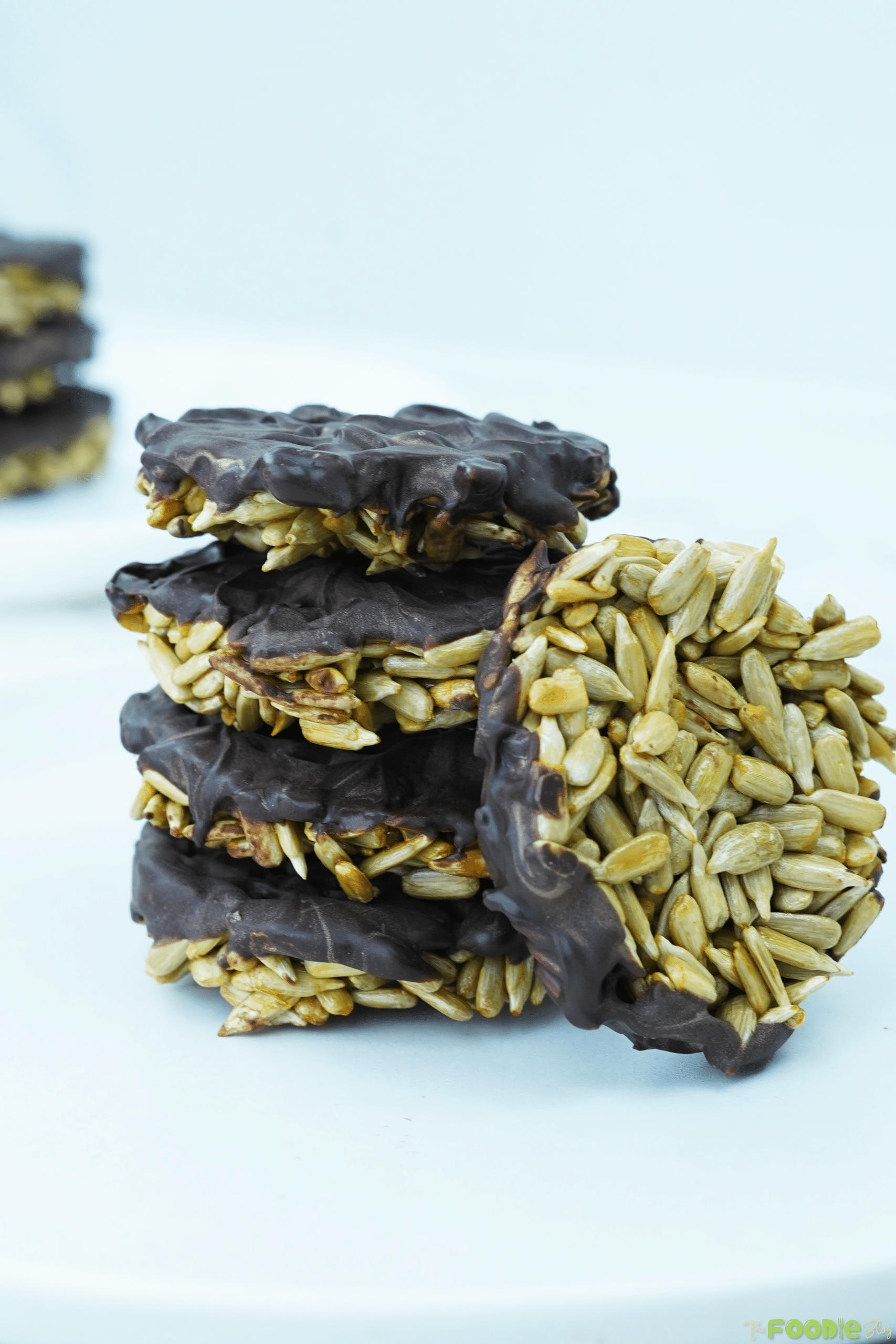 Close-up of stacked sunflower seed chocolate bites with chocolate coating