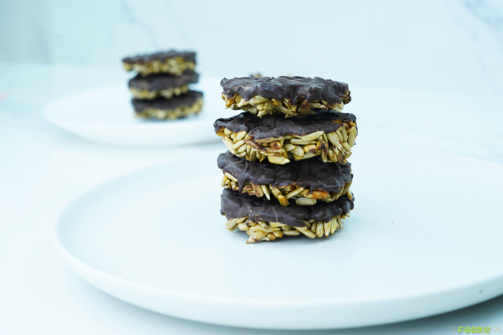 Stack of sunflower seed chocolate bites on a white plate