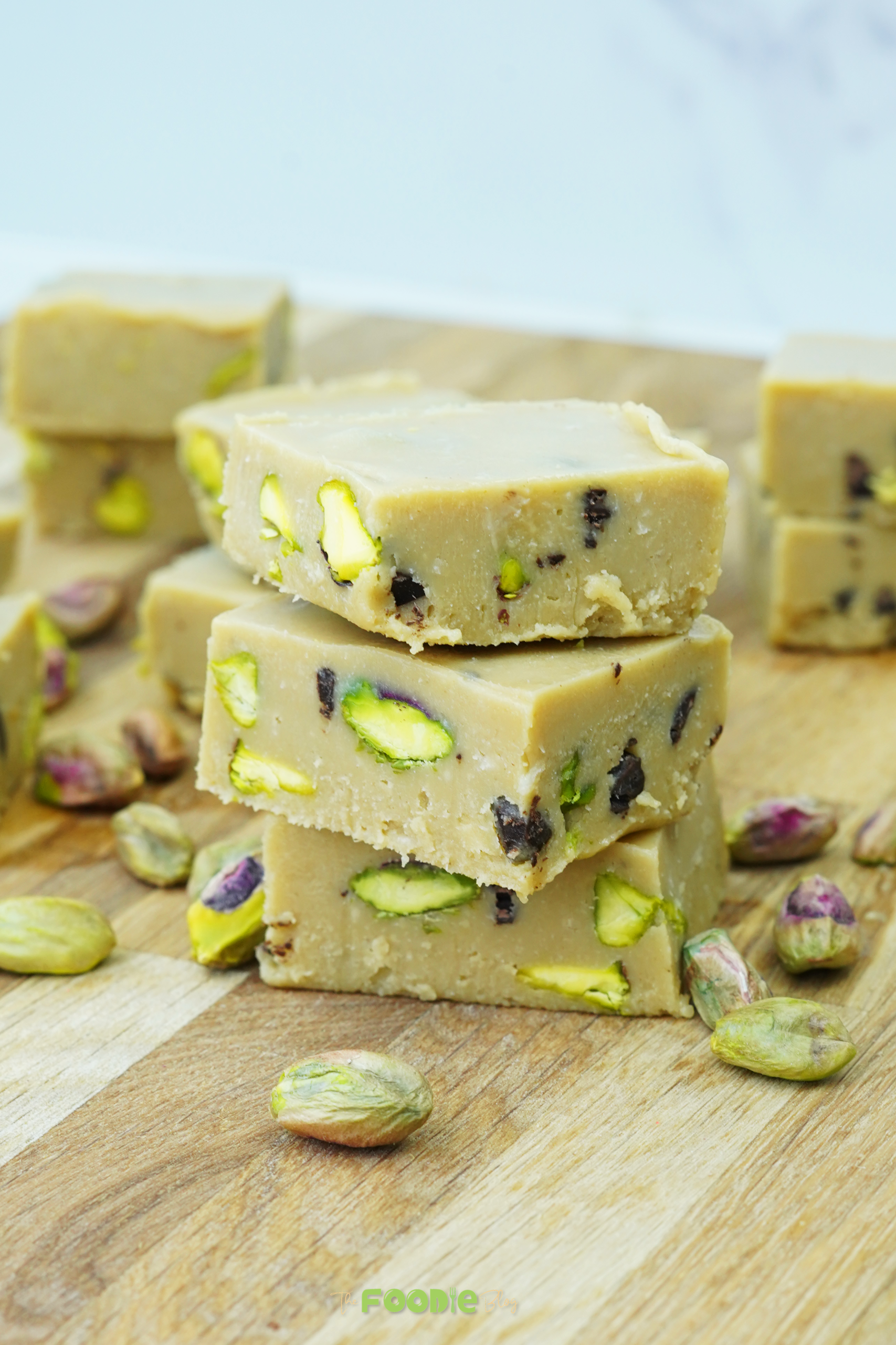 Close-up of tahini fudge squares showing pistachios and chocolate pieces