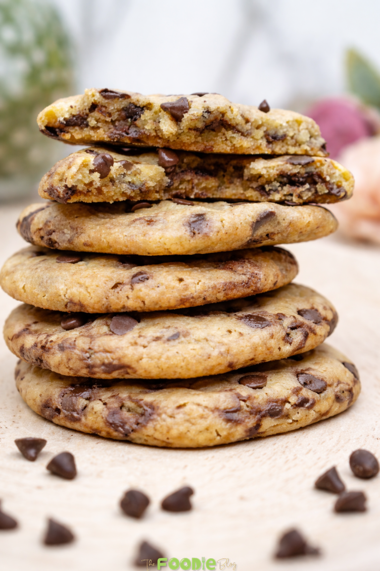 The Best Chocolate Chip Cookies Recipe served on a black plate with broken cookie pieces and chocolate chips