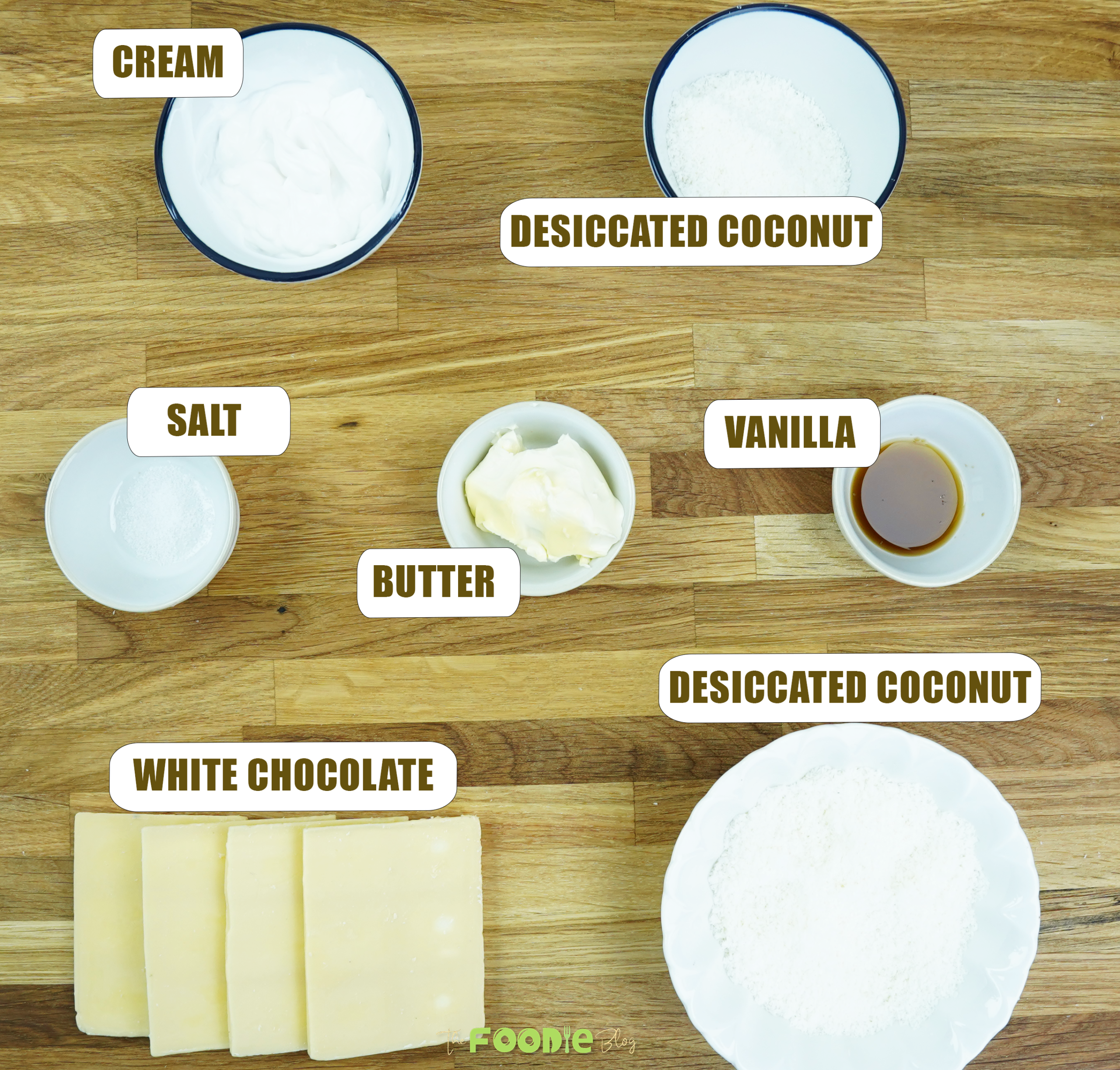 Ingredients laid out for white chocolate truffles including white chocolate, cream, butter, vanilla, salt, and desiccated coconut