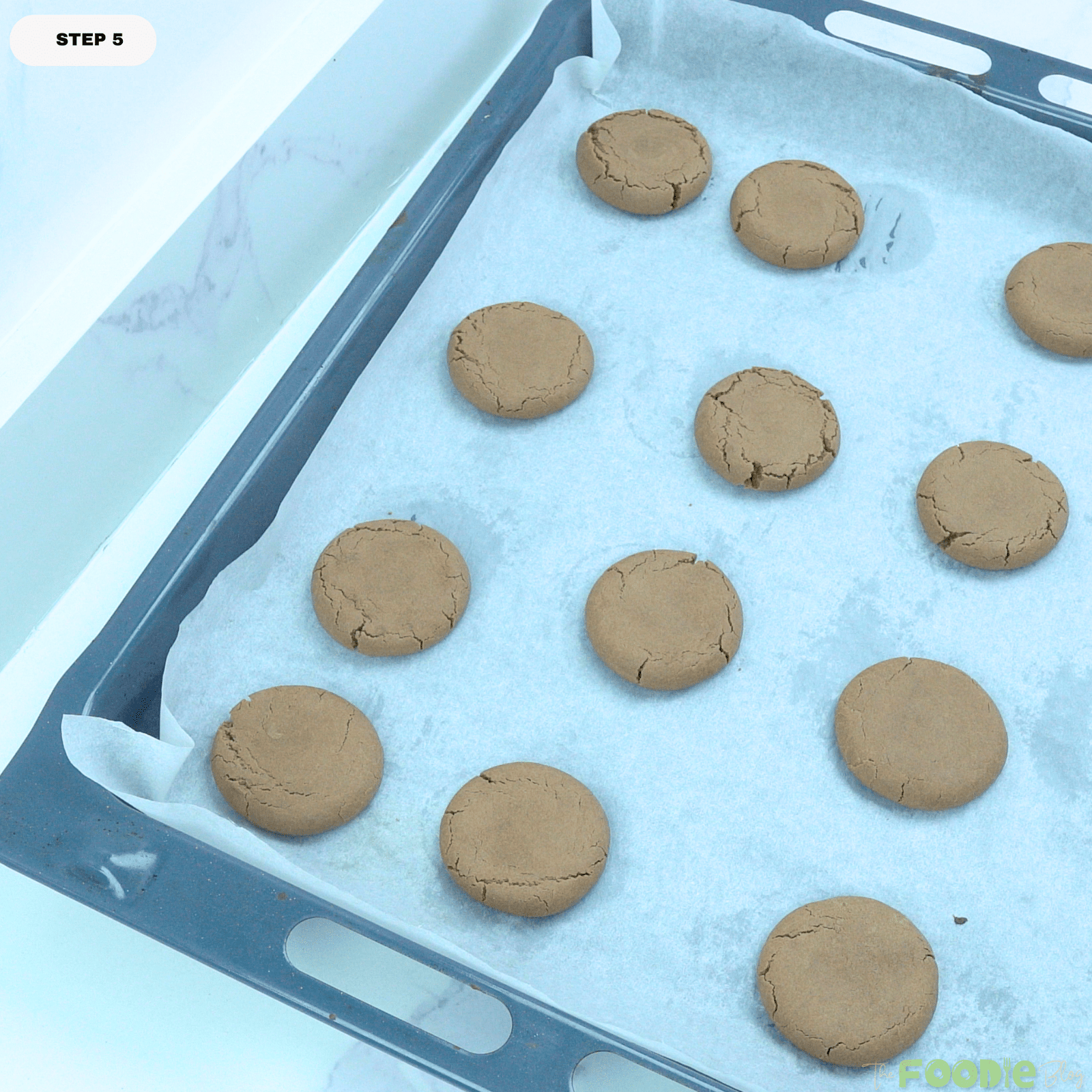 Freshly baked Nutella cookies cooling on a parchment-lined baking sheet